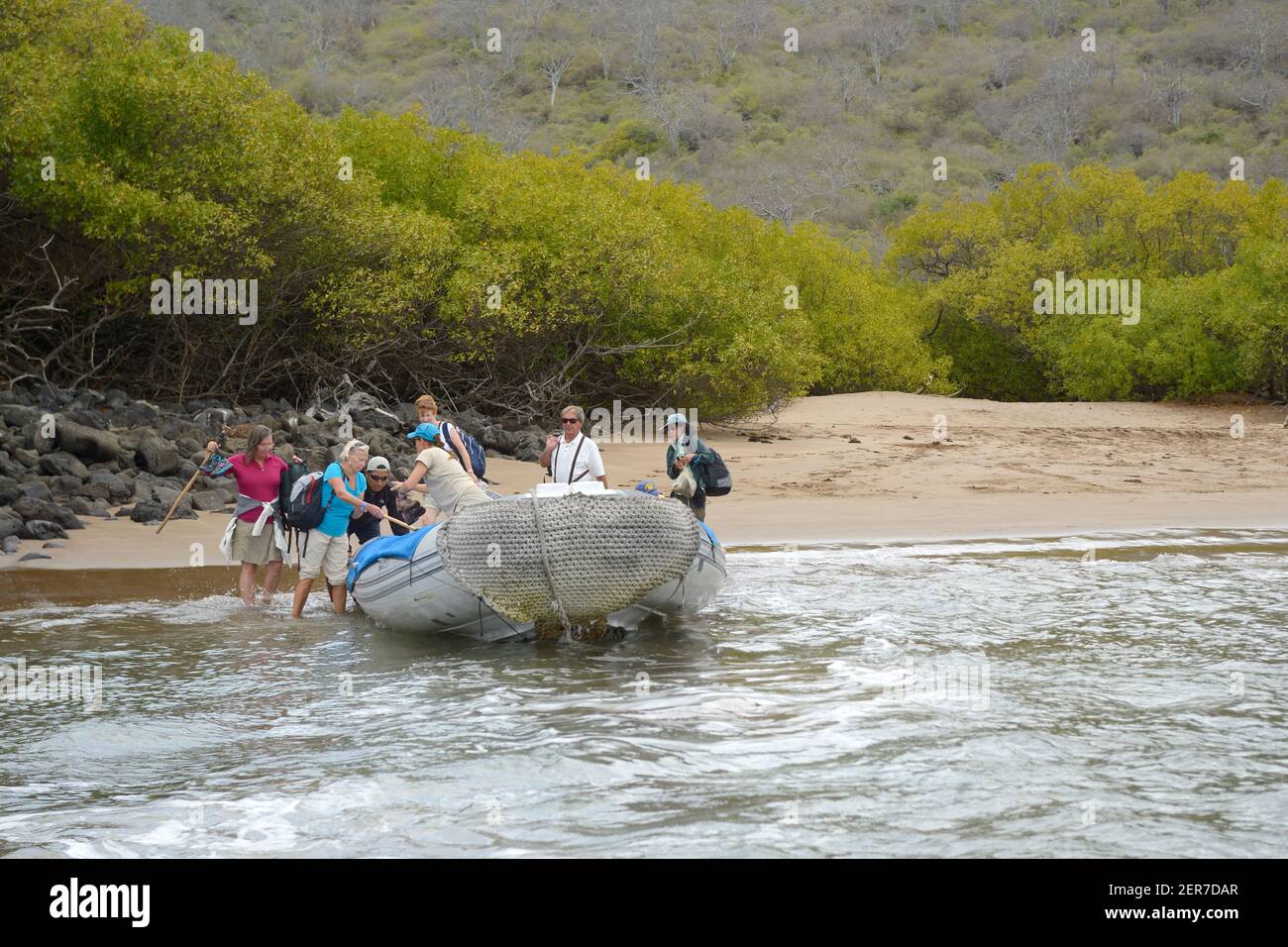 Climbing into the panga at Espumilla Beach, Santiago Island, Galapagos