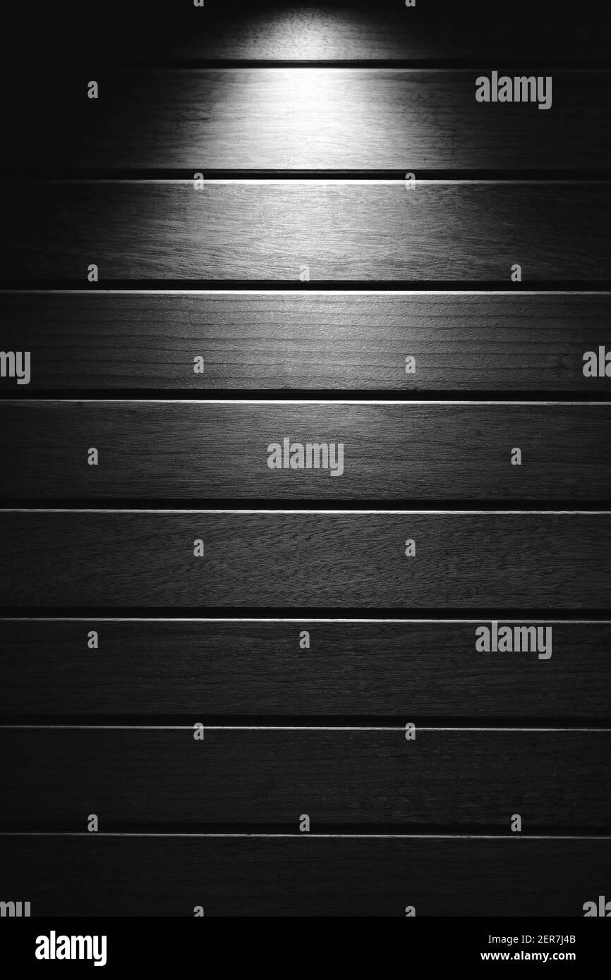 Yellow light radiating from above on the wooden floor, copy space Stock