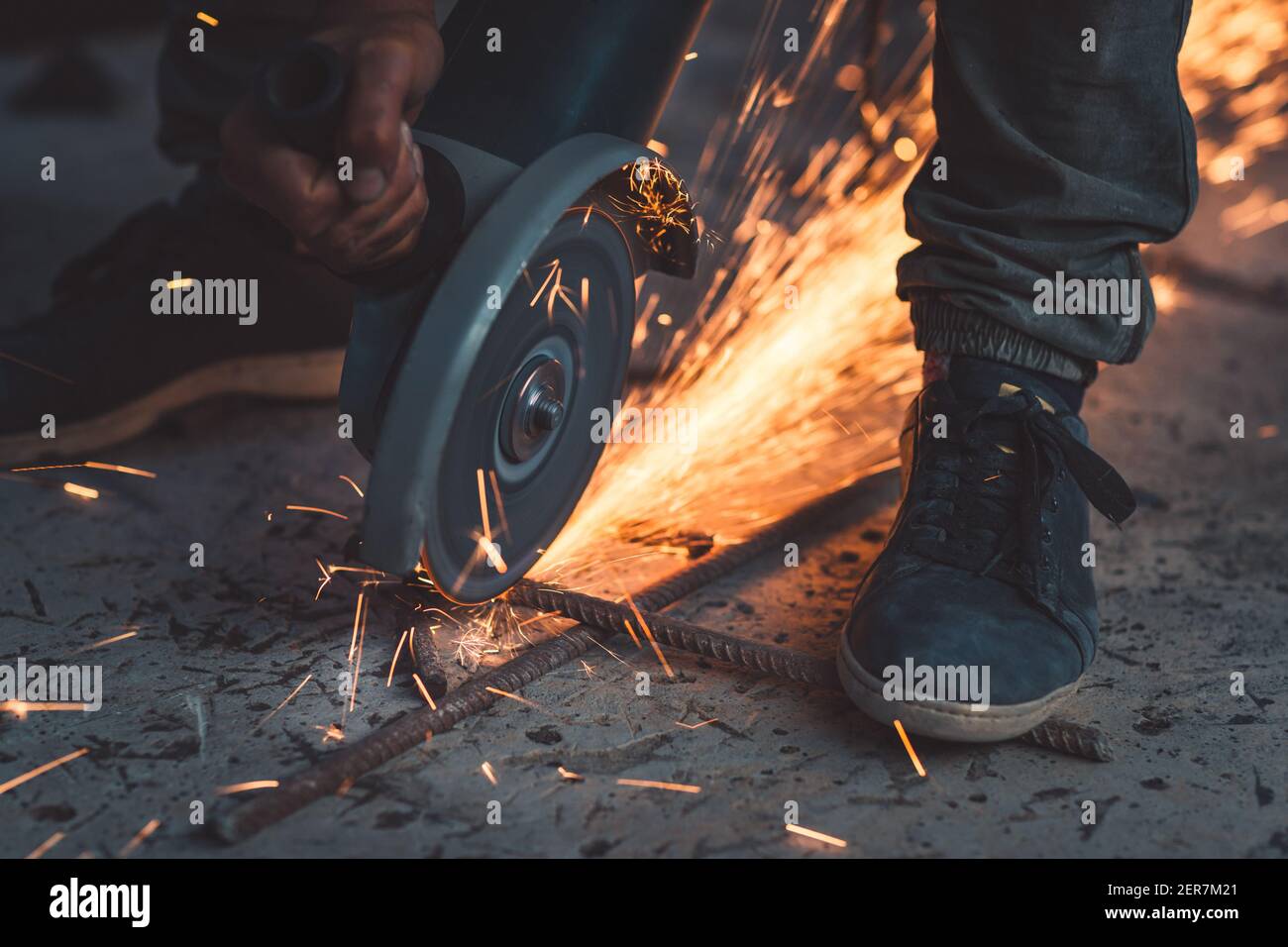 Close Up on the Hot Bright Sparks Fly Out from under the Steel Cutter. Hard Work Duty. Blue-Collar Jobs. Stock Photo