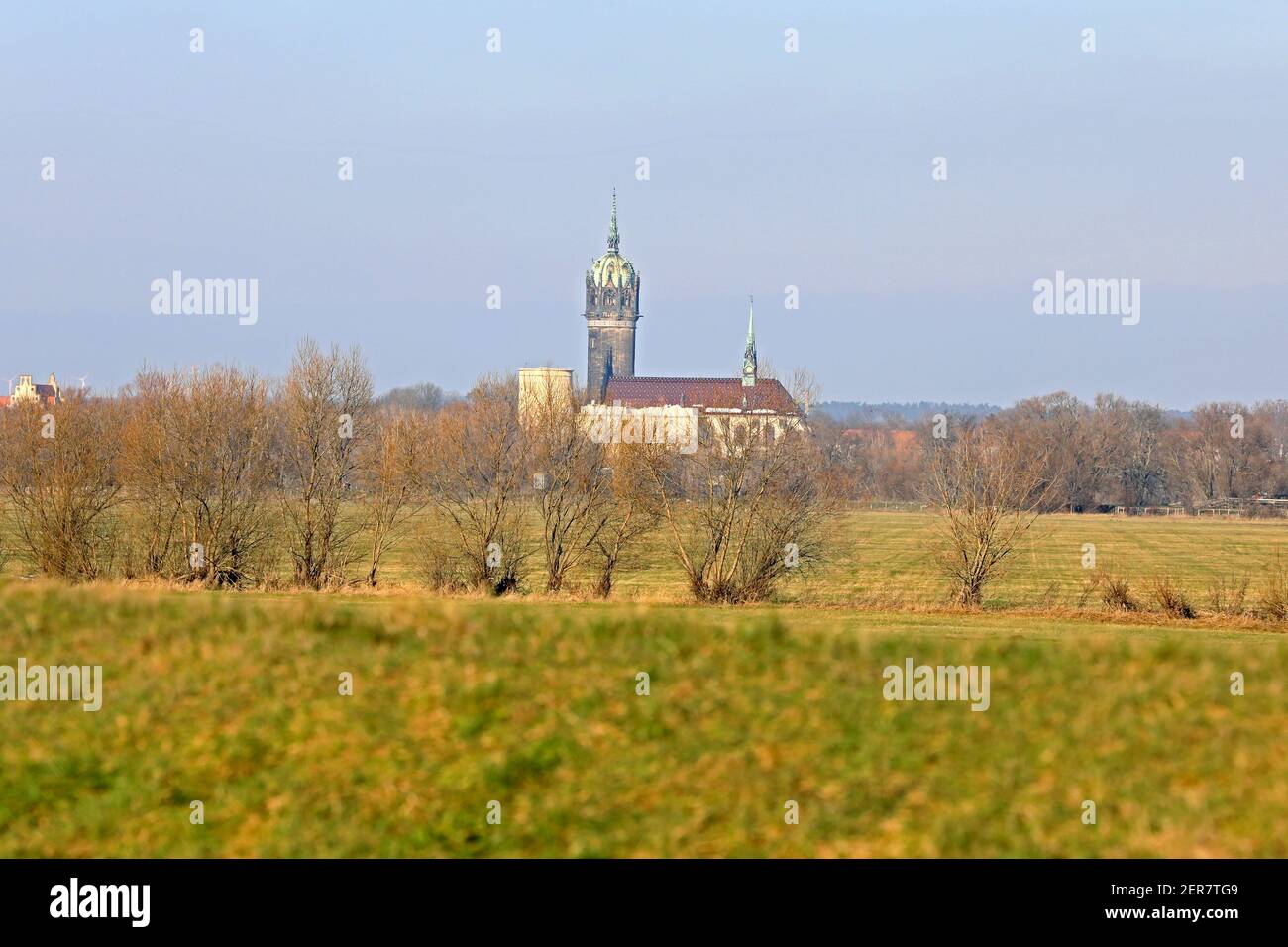 Wittenberg, Germany. 17th Jan, 2021. View over fields to the castle church in the center of Lutherstadt. The Castle Church, also known as the Church of the Reformation, is a Protestant church in Lutherstadt Wittenberg and has been a UNESCO World Heritage Site since 1996. It is considered the starting point of the Reformation after Martin Luther spread his 95 Latin disputation theses from here on 31 October 1517. Credit: Peter Gercke/dpa-Zentralbild/ZB/dpa/Alamy Live News Stock Photo