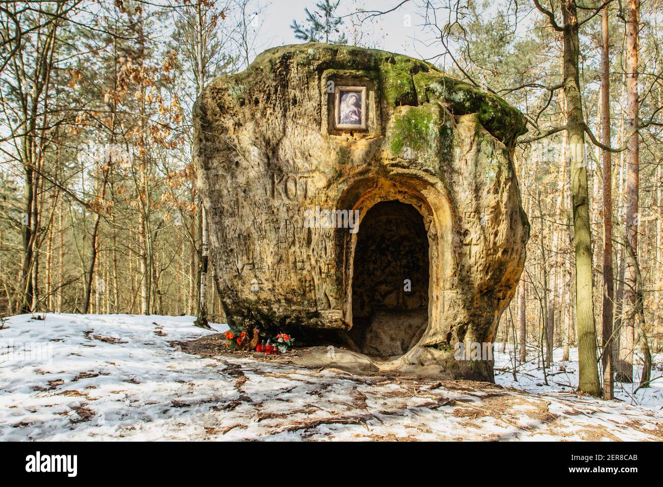 The cave and Chapel of Mary Magdalene carved in sandstone.Artworks in pine forest near Zelizy village,Czech Republic.Outdoor altar in park no people. Stock Photo