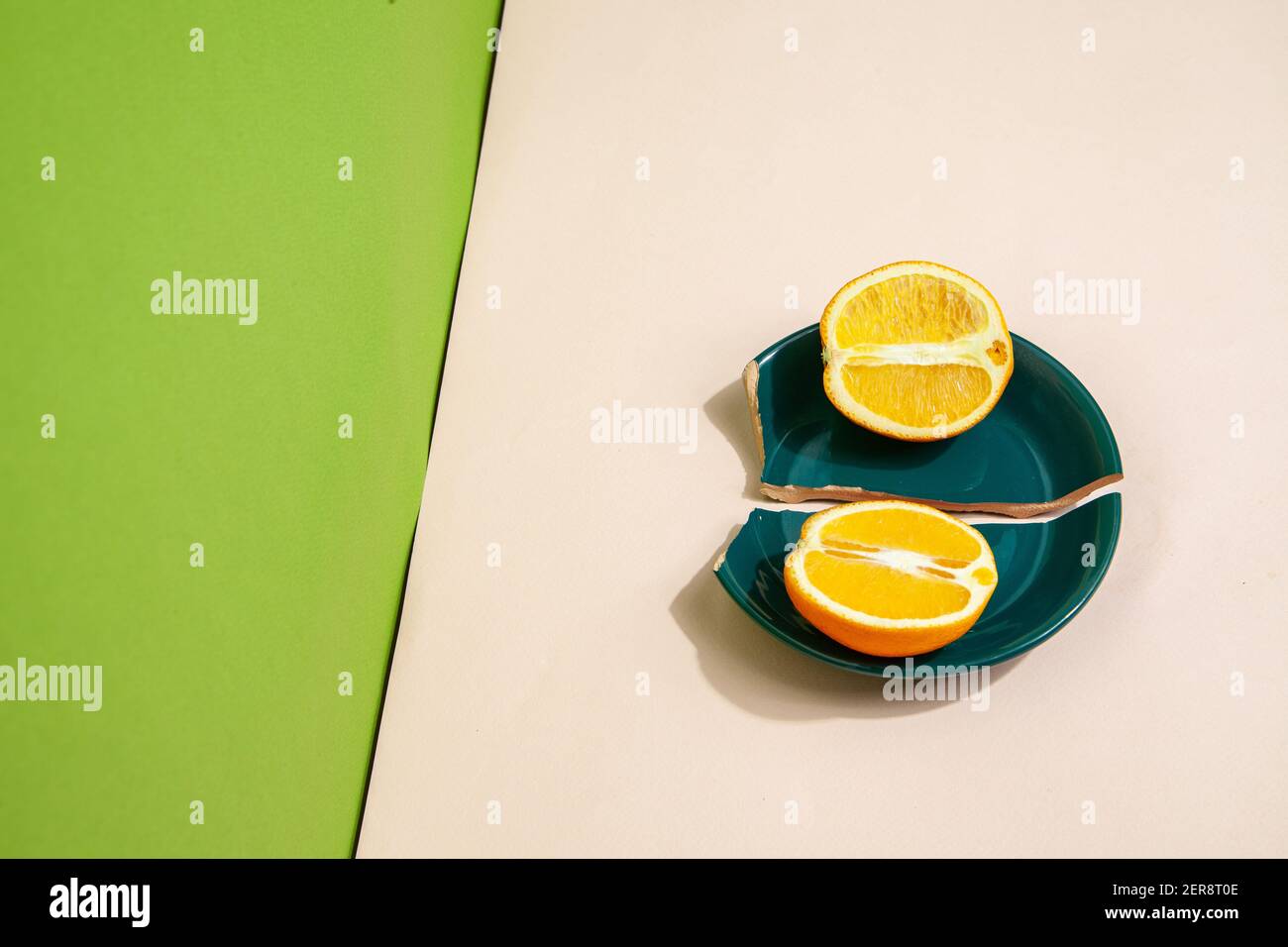 Pieces of fresh orange on broken plate Stock Photo