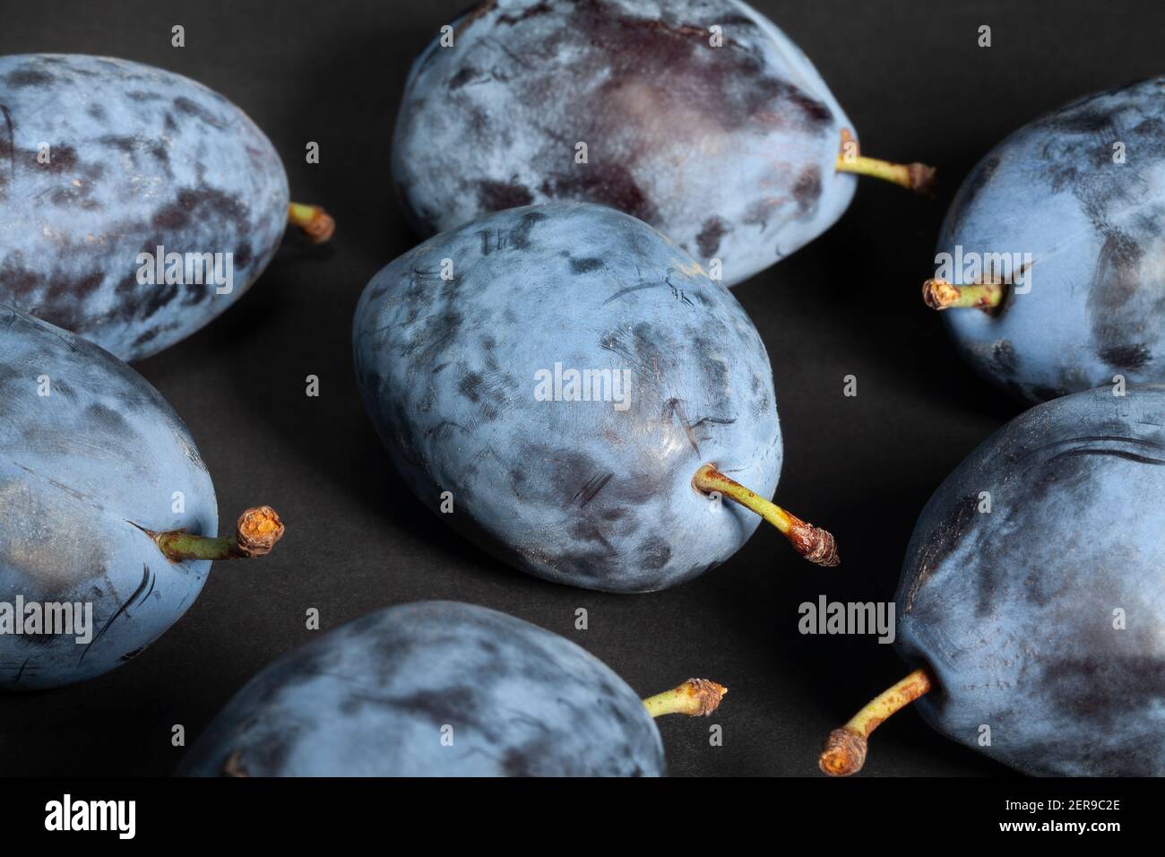 blue plums on black background Stock Photo