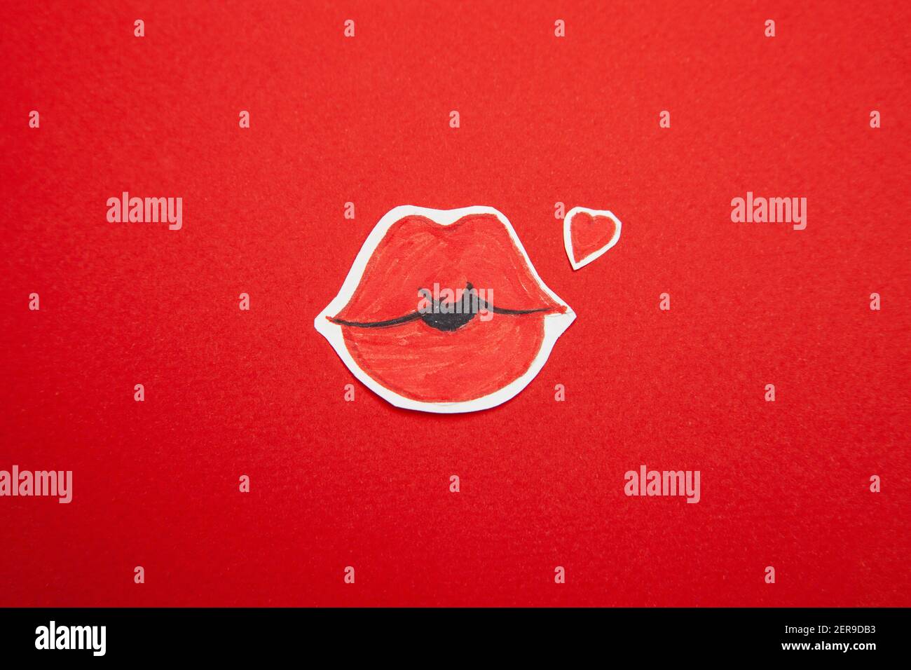 Red lips and heart painted on cut paper Stock Photo Alamy