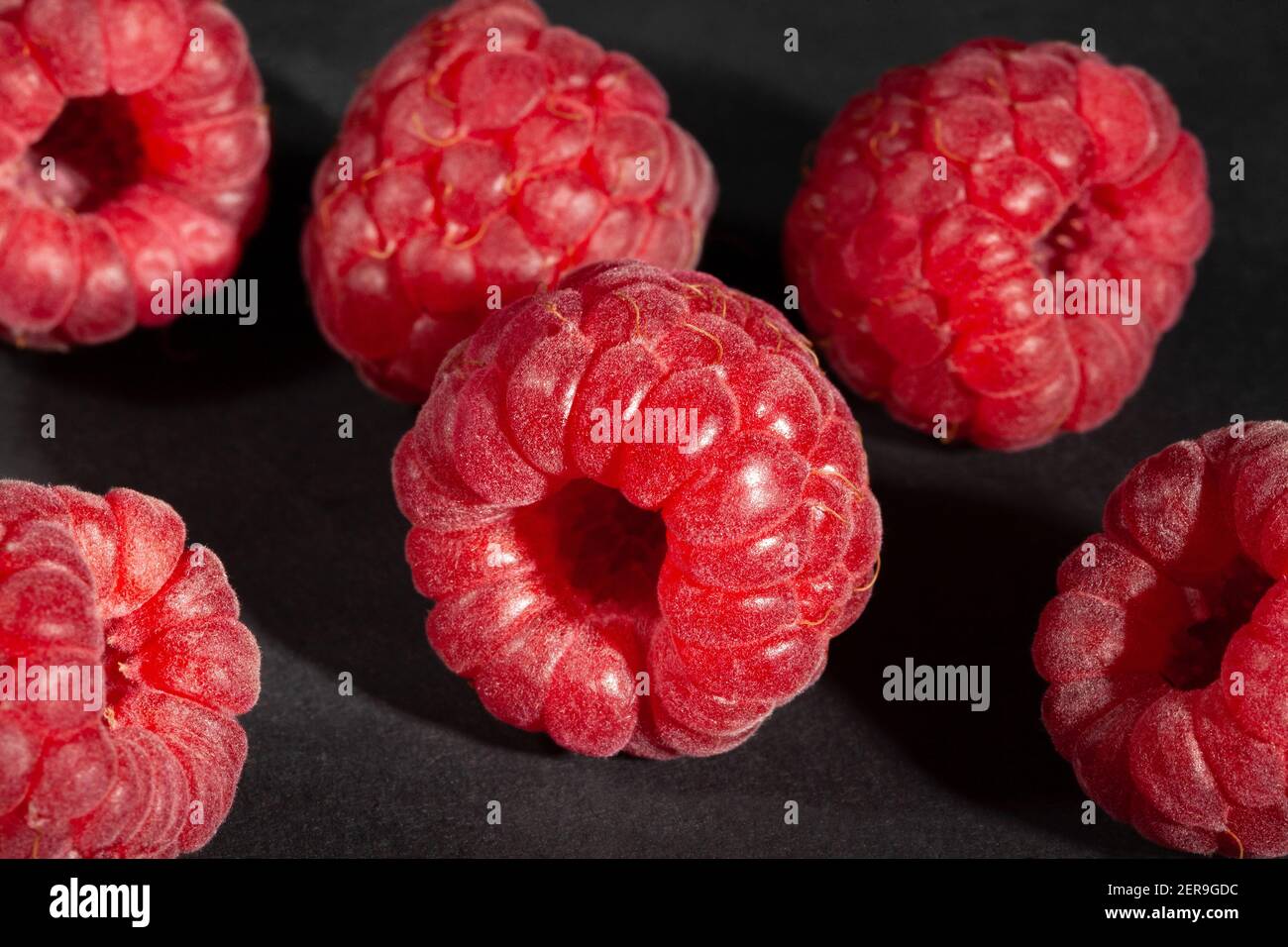 raspberry group on black background Stock Photo Alamy