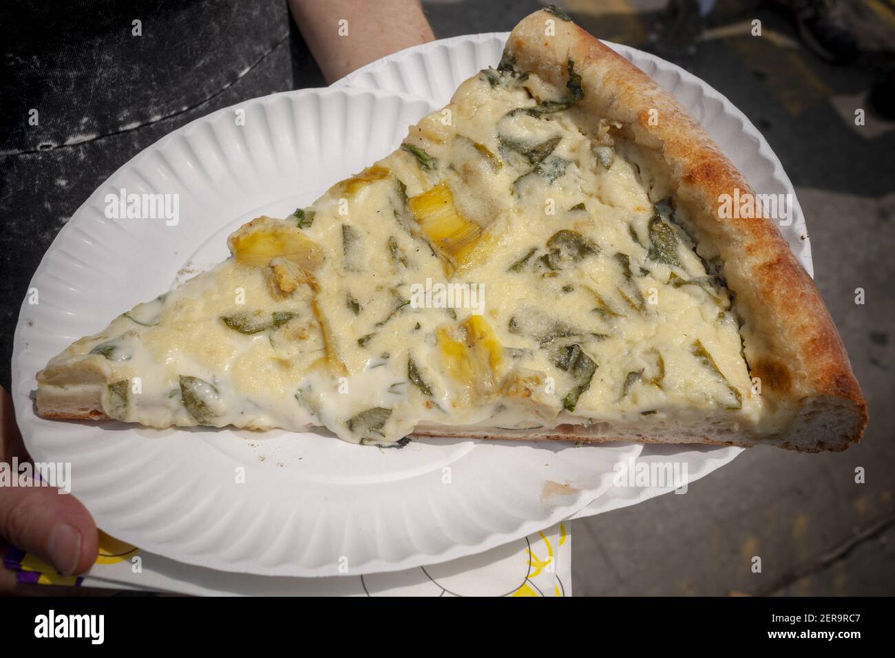 A slice of pizza from the popular Artichoke Basille's Pizza's newly