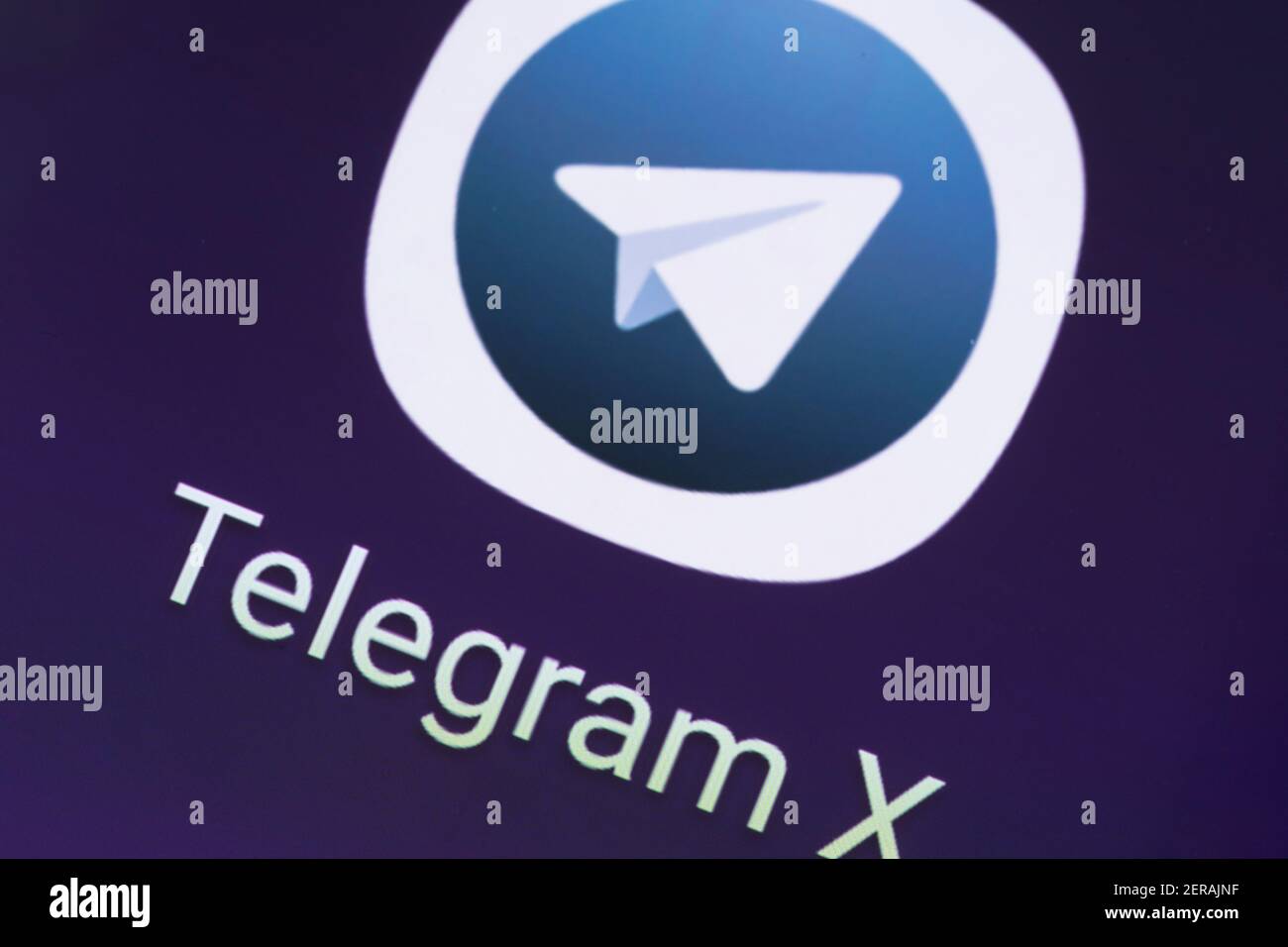 A macro closeup of the Telegram X app logo - Telegram X is a freeware, cross-platform, cloud-based instant messaging and voIP video calling service Stock Photo