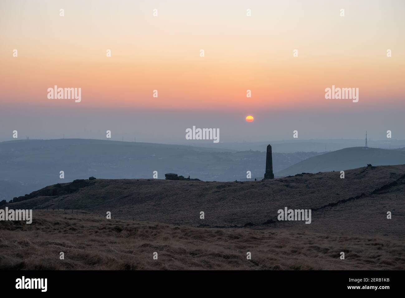 Sunset over war memorial obelisk on Alderman's hill (aka Pots and Pans hill) in Saddleworth, England, UK Stock Photo
