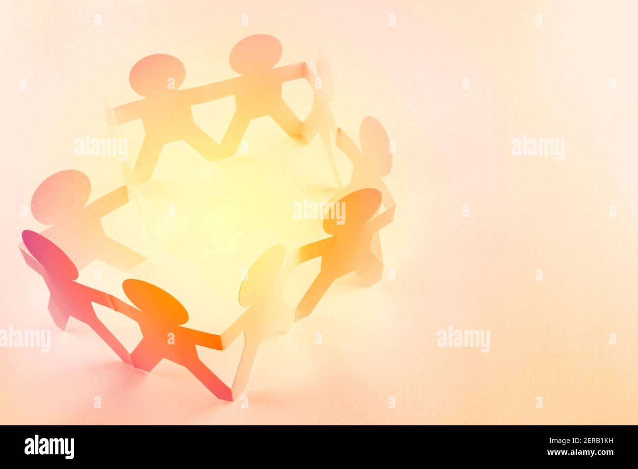 Team of paper chain people holding hands Stock Photo - Alamy