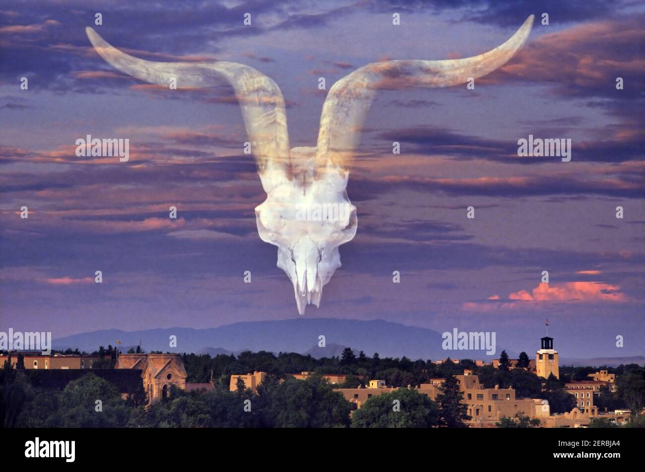 Double exposure with Santa Fe sunset and ram's skull in the sky. Stock Photo