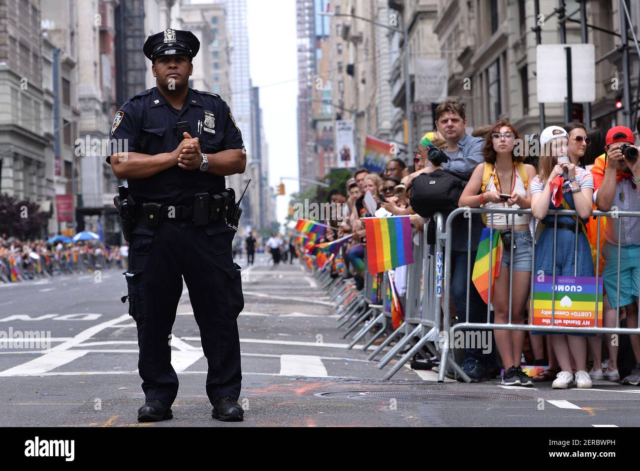 An NYPD officer stands guard along Fifth Avenue during the 2018 New ...