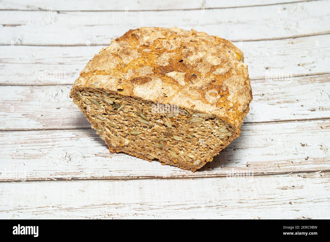 Homemade seeded whole grain sourdough bread with oats, sunflower seeds, pumpkin sees and flaxseed. Stock Photo