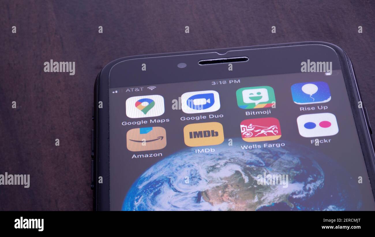 MINNEAPOLIS, MINNESOTA / USA - FEBRUARY 28, 2021: Person using Apple i-phone to press and access the new Amazon logo app / application Stock Photo
