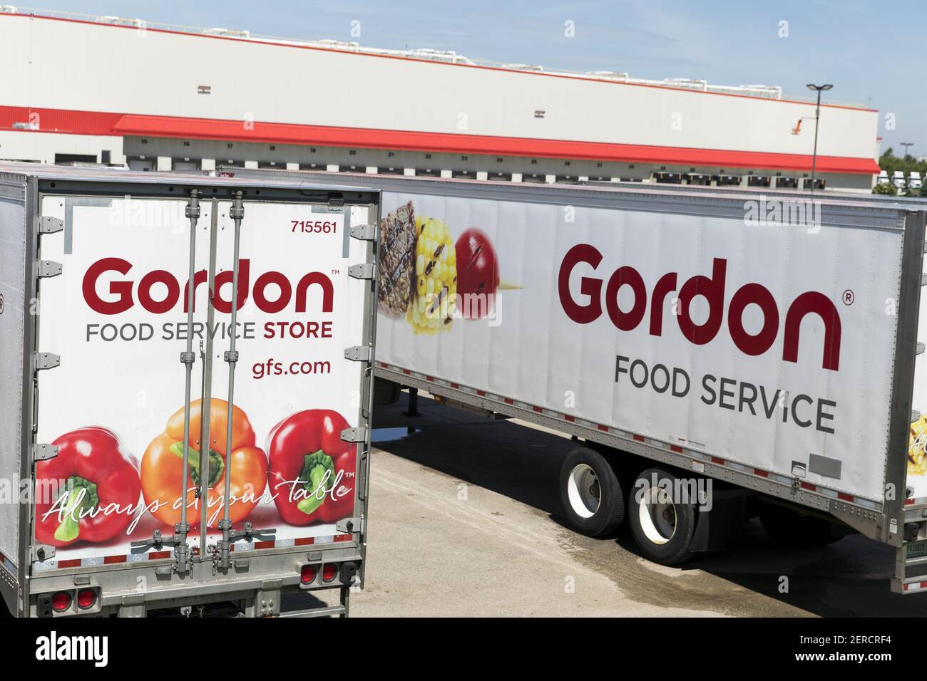 Semi trucks and trailers featuring Gordon Food Service logos outside of