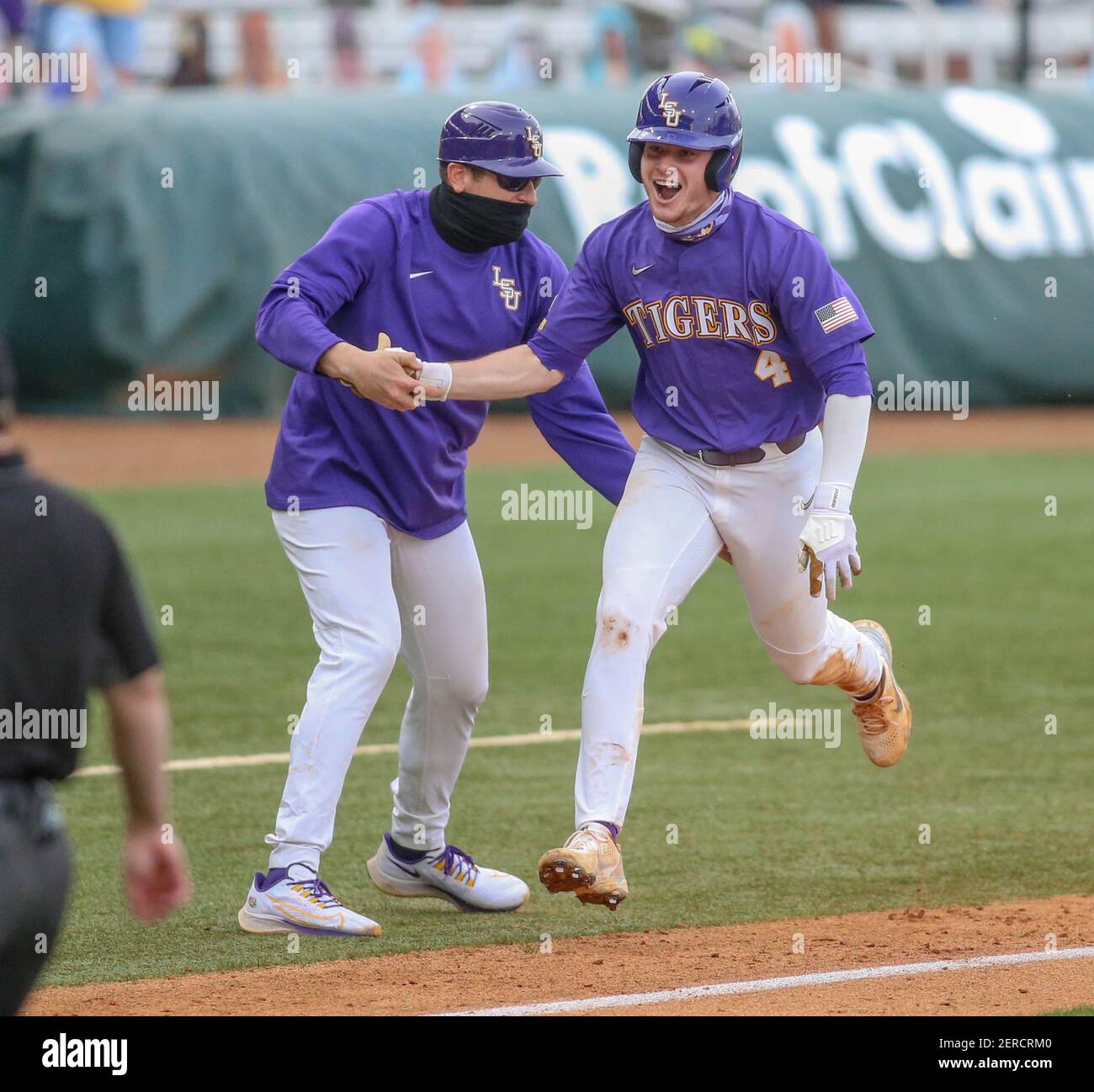 Baton Rouge, LA, USA. 27th Feb, 2021. LSU's Cade Doughty (4) celebrates  with third base coach Nolan Cain after delivering a two run game winning  home run in the 9th inning of