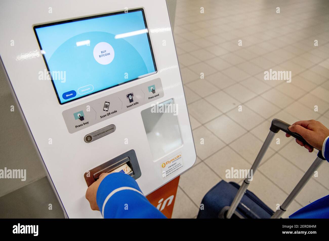 Travelers at Schiphol who wish to spend their last euros shortly before  departure can exchange these for bitcoin and ethereum cryptocurrences in  Amsterdam, Netherlands on June 20, 2018. A bitcoin machine was
