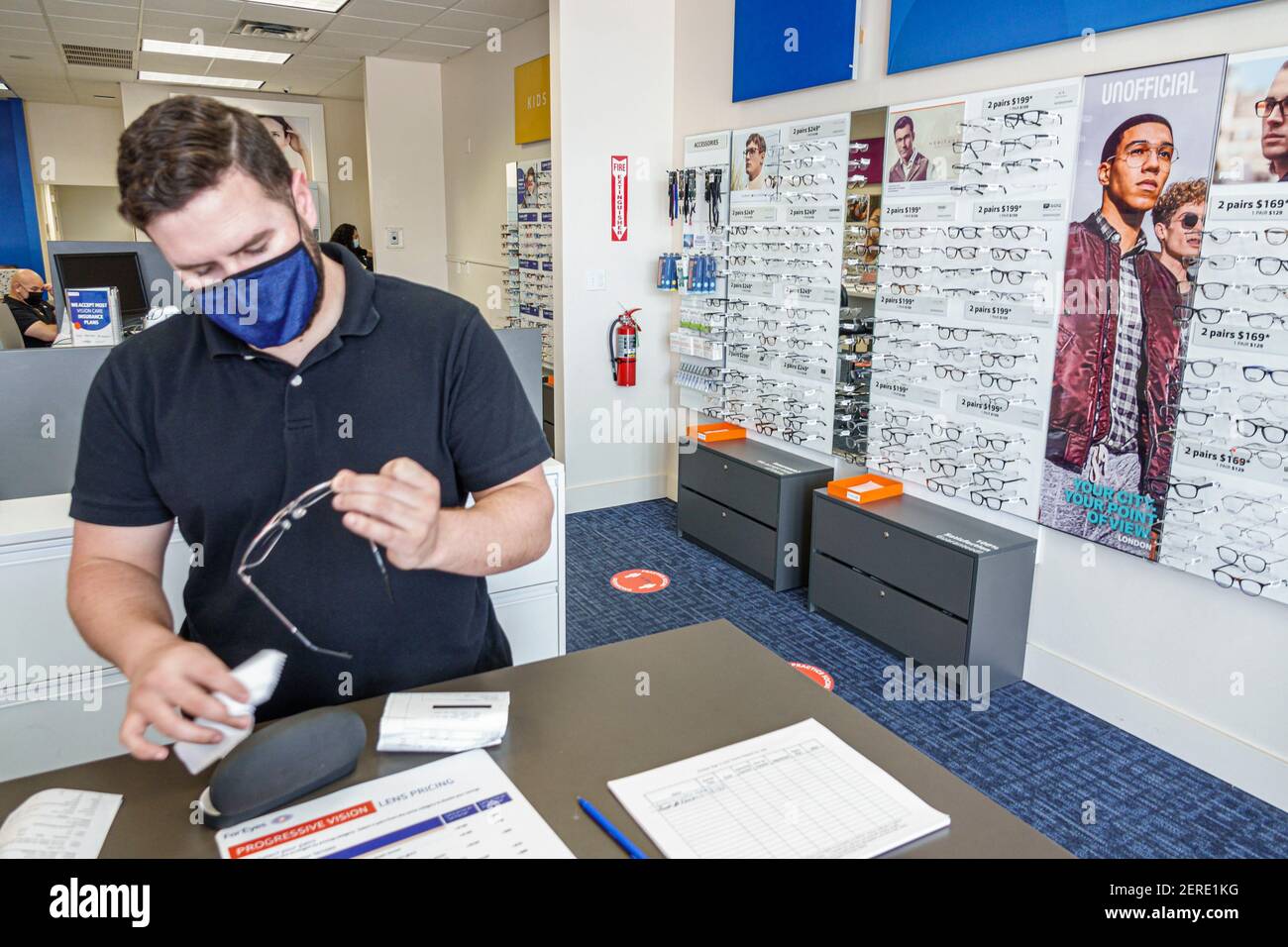 Miami Beach Florida,eyeglass eyeglasses store business optician optometrist cleaning glasses,man men male adult adults,employee employees worker worke Stock Photo