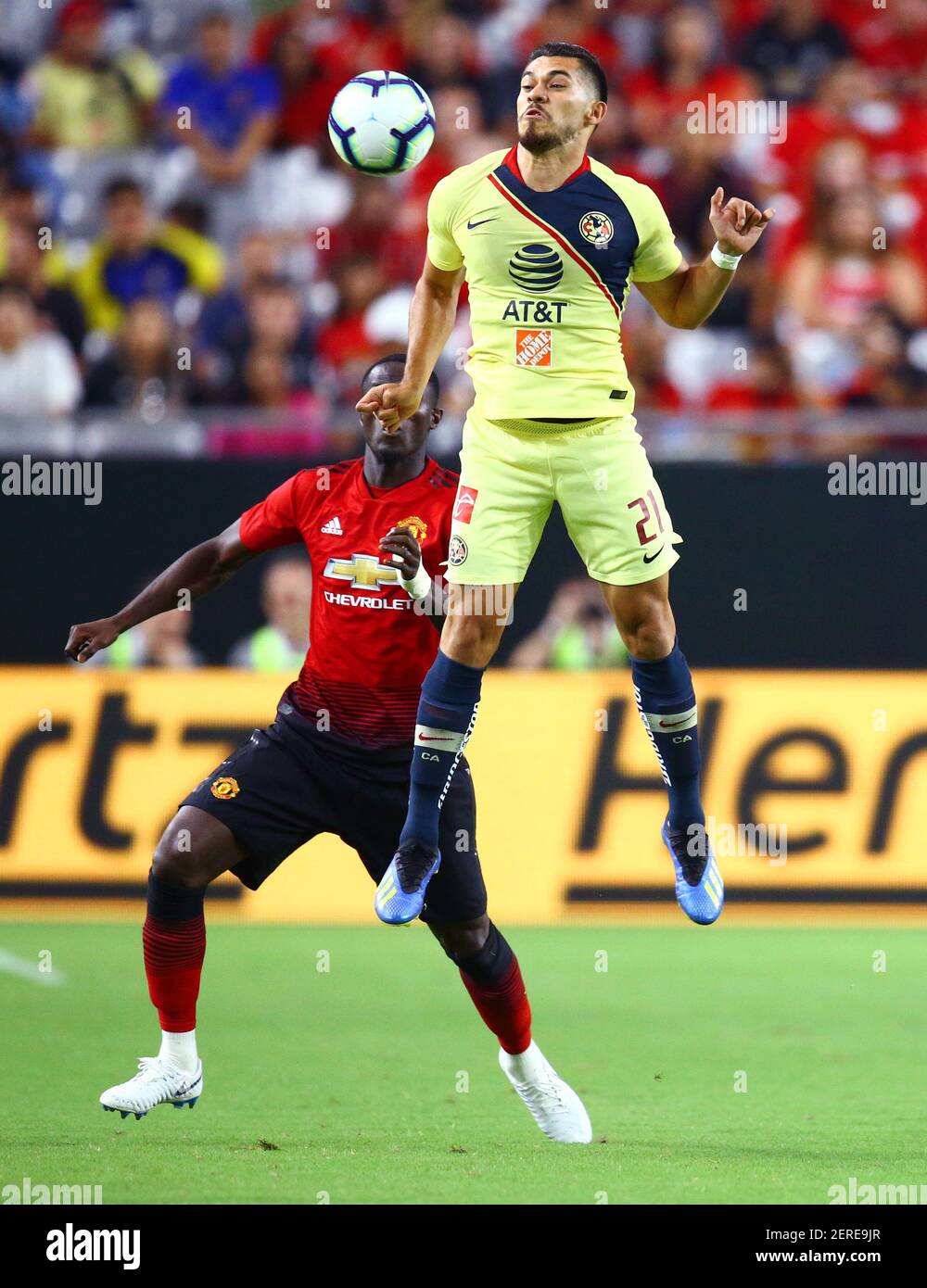 Jul 19, 2018; Glendale, AZ, USA; Club America forward Henry Martin (21)  leaps to stop the ball against Manchester United during the first half of  an international friendly soccer match at University