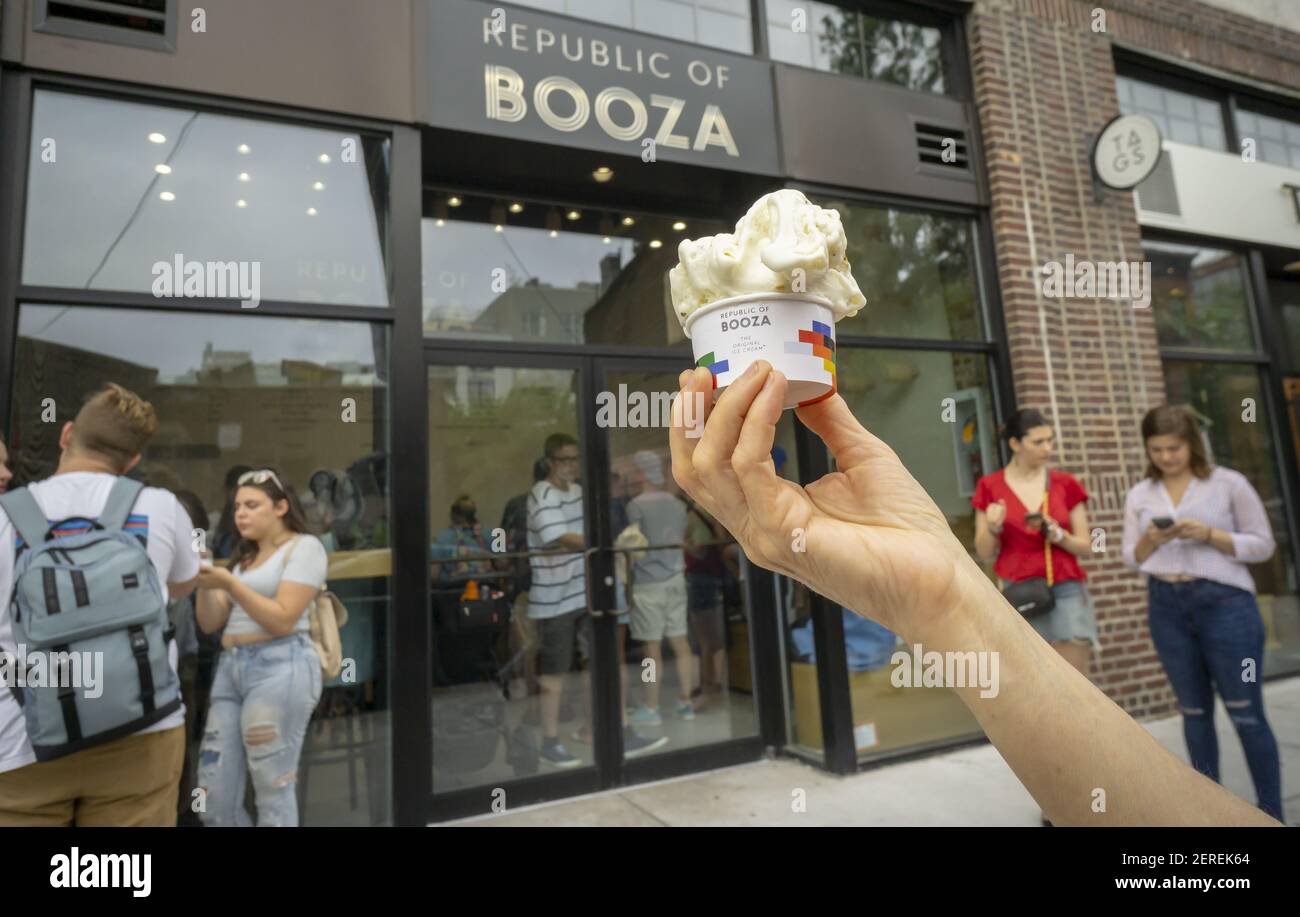 An ice cream lover holds up her cup of booza ice cream, from the ice