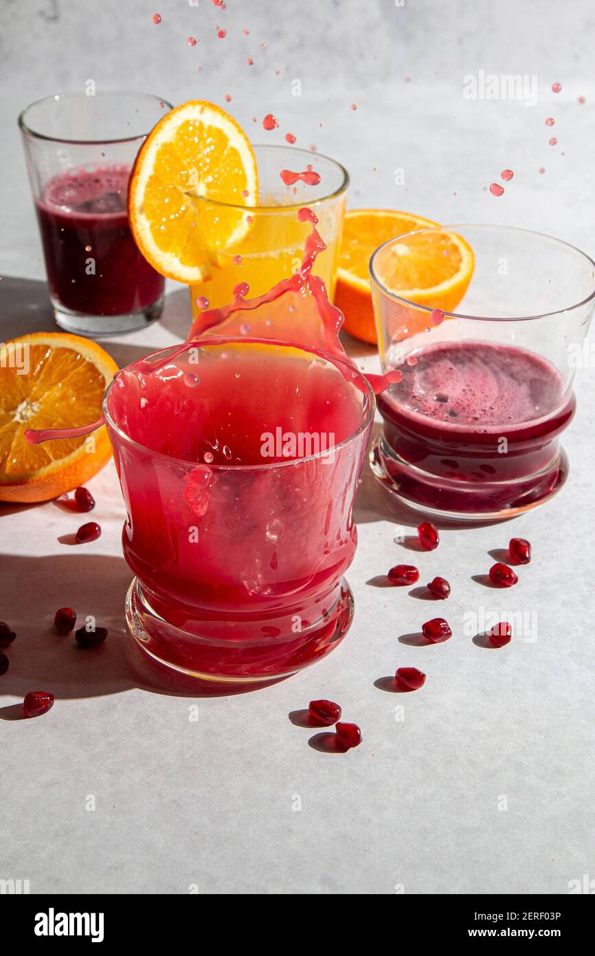 Pomegranate and orange juice splash motion Stock Photo