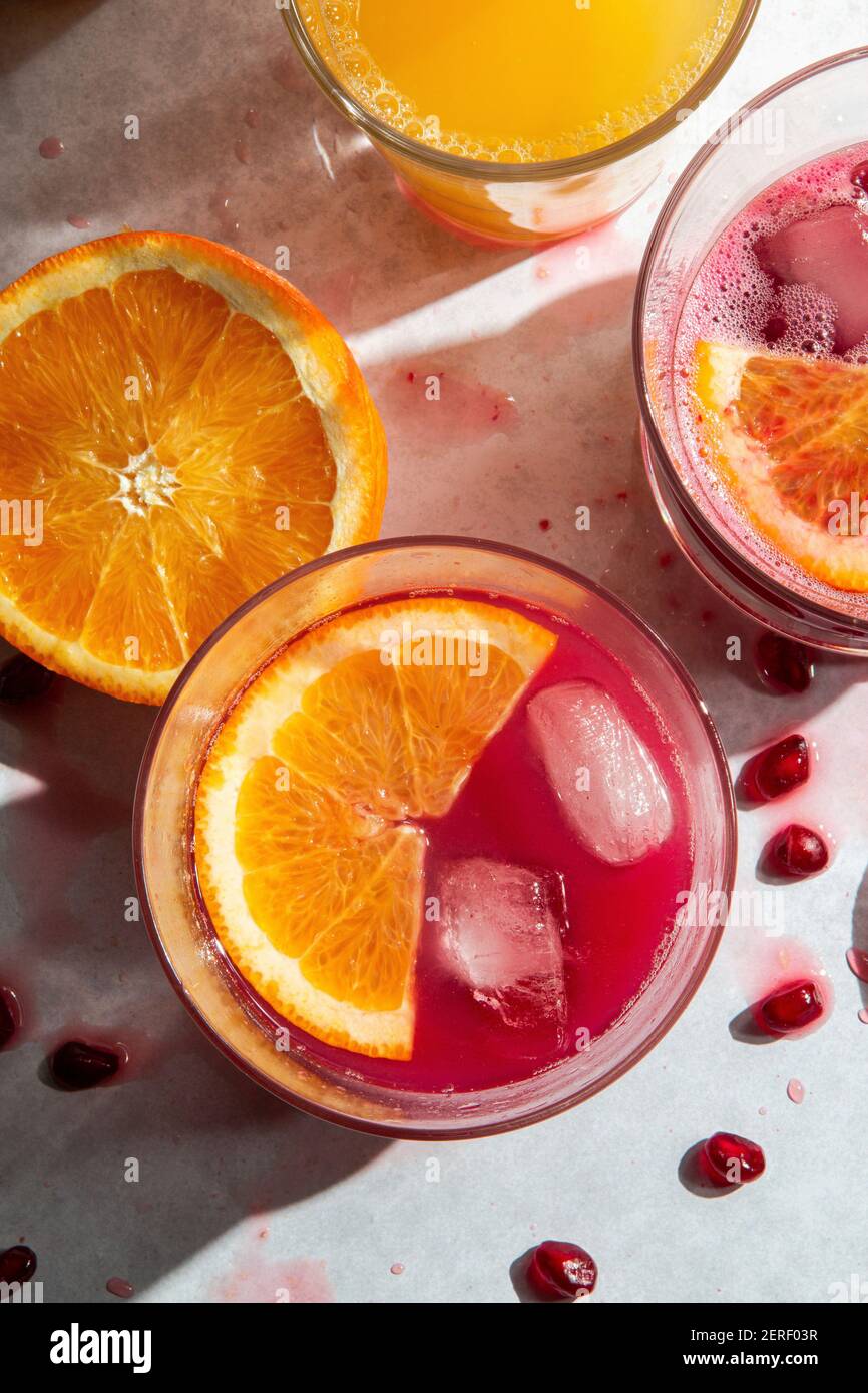 Fresh squeezed pomegranate and orange juice in glasses Stock Photo