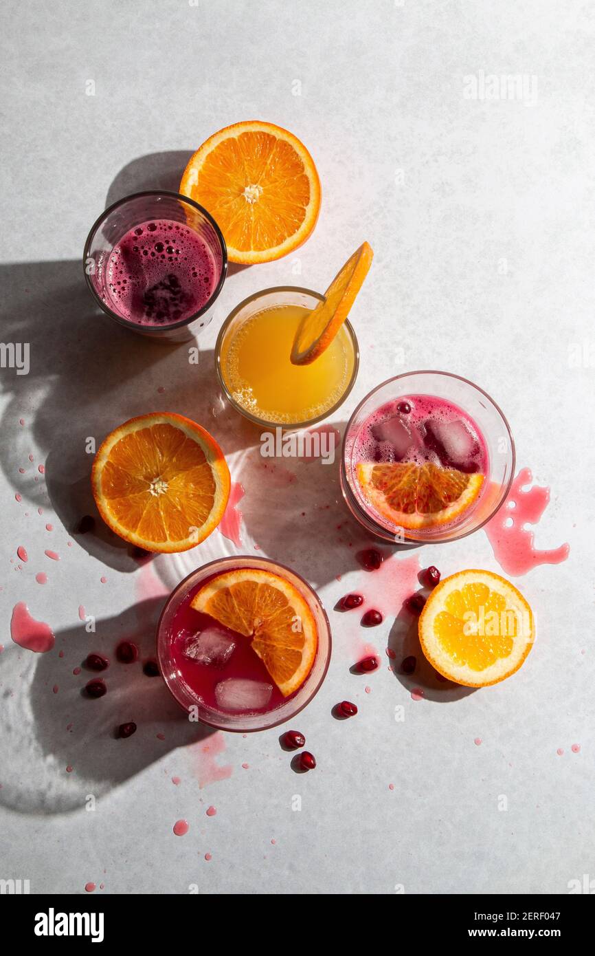 Fresh squeezed pomegranate and orange juice in glasses Stock Photo