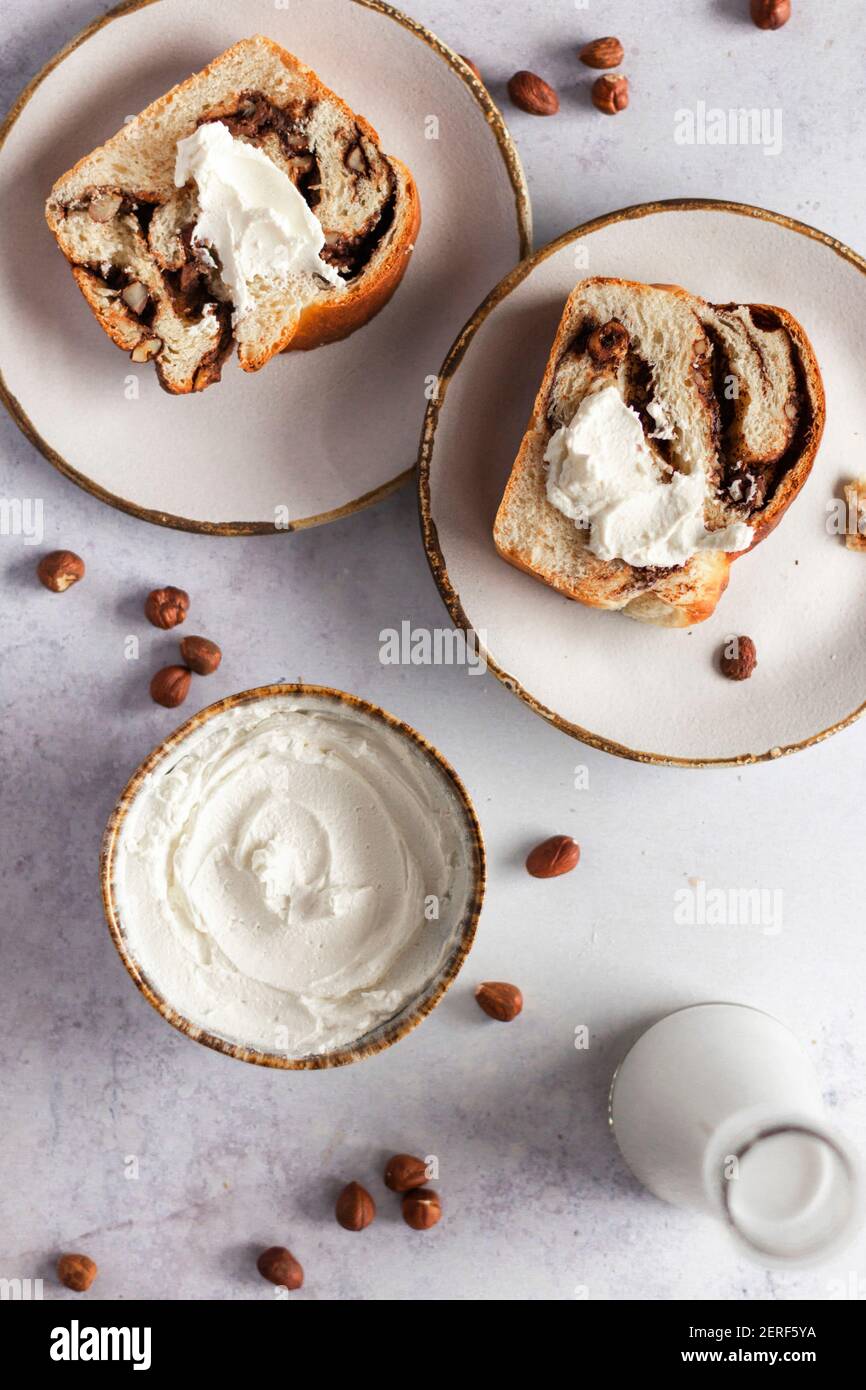 Chocolate and hazelnut babka served with cream cheese. Stock Photo