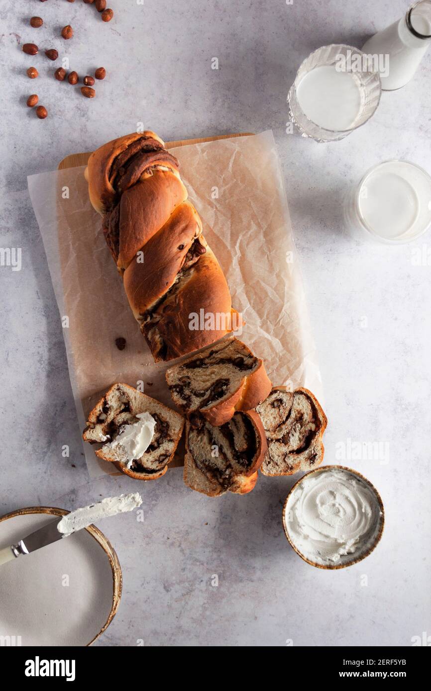 Chocolate and hazelnut babka served with cream cheese. Stock Photo