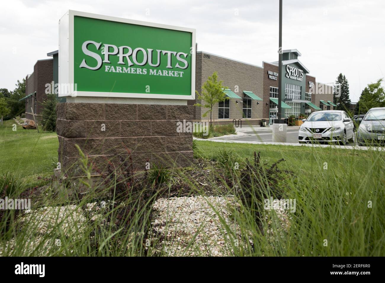 A logo sign outside of Sprouts Farmers Market retail grocery store in