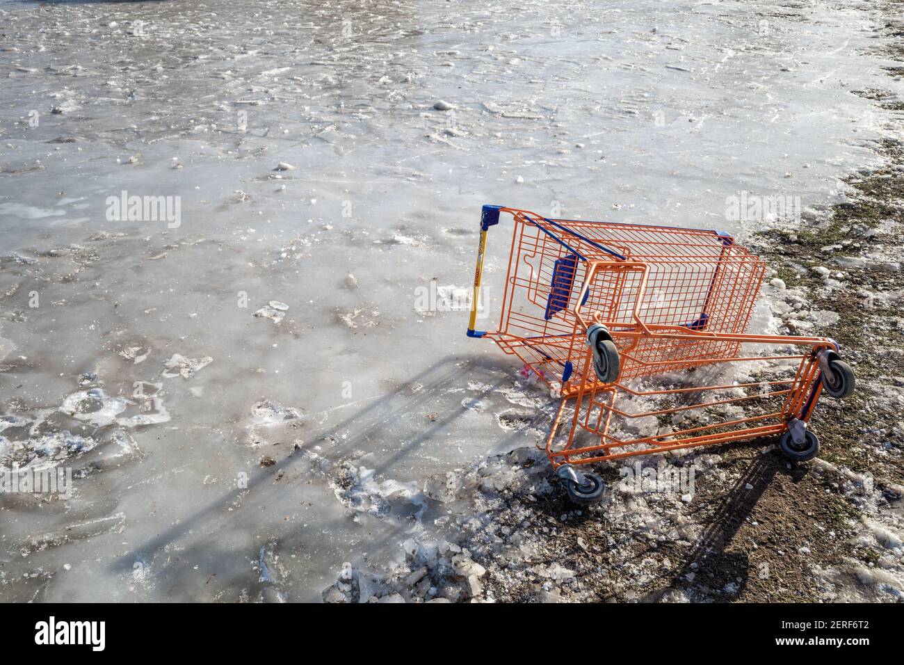 Broken shopping cart on outdoor icy ground Stock Photo Alamy