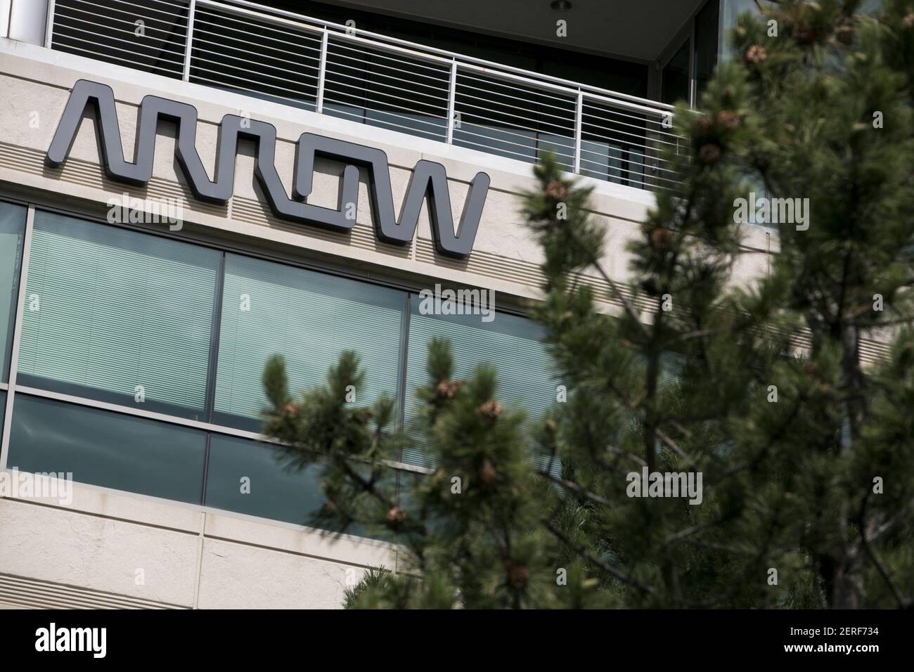 A logo sign outside of the headquarters of Arrow Electronics in