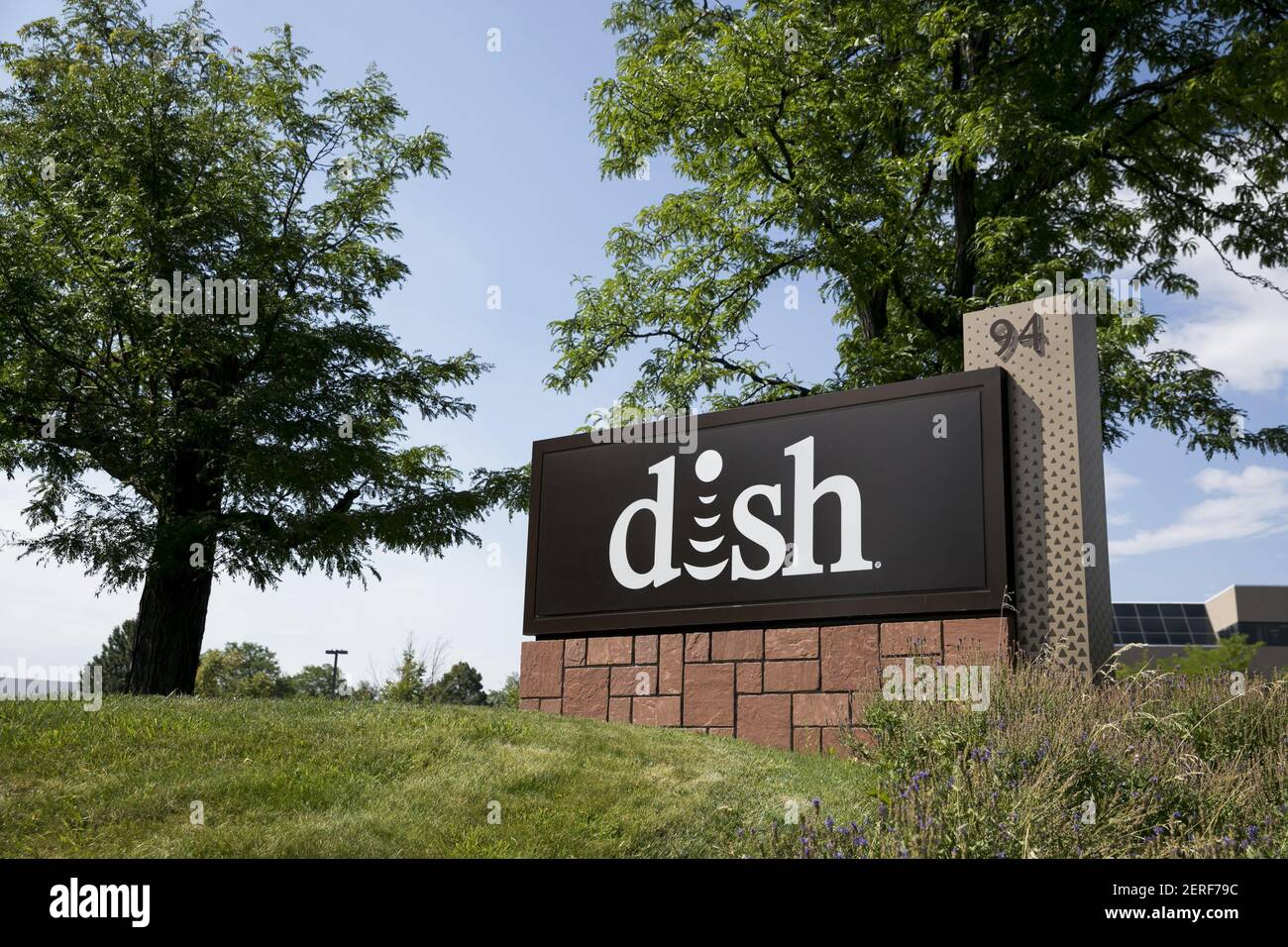 A logo sign outside of a facility occupied by the Dish Network