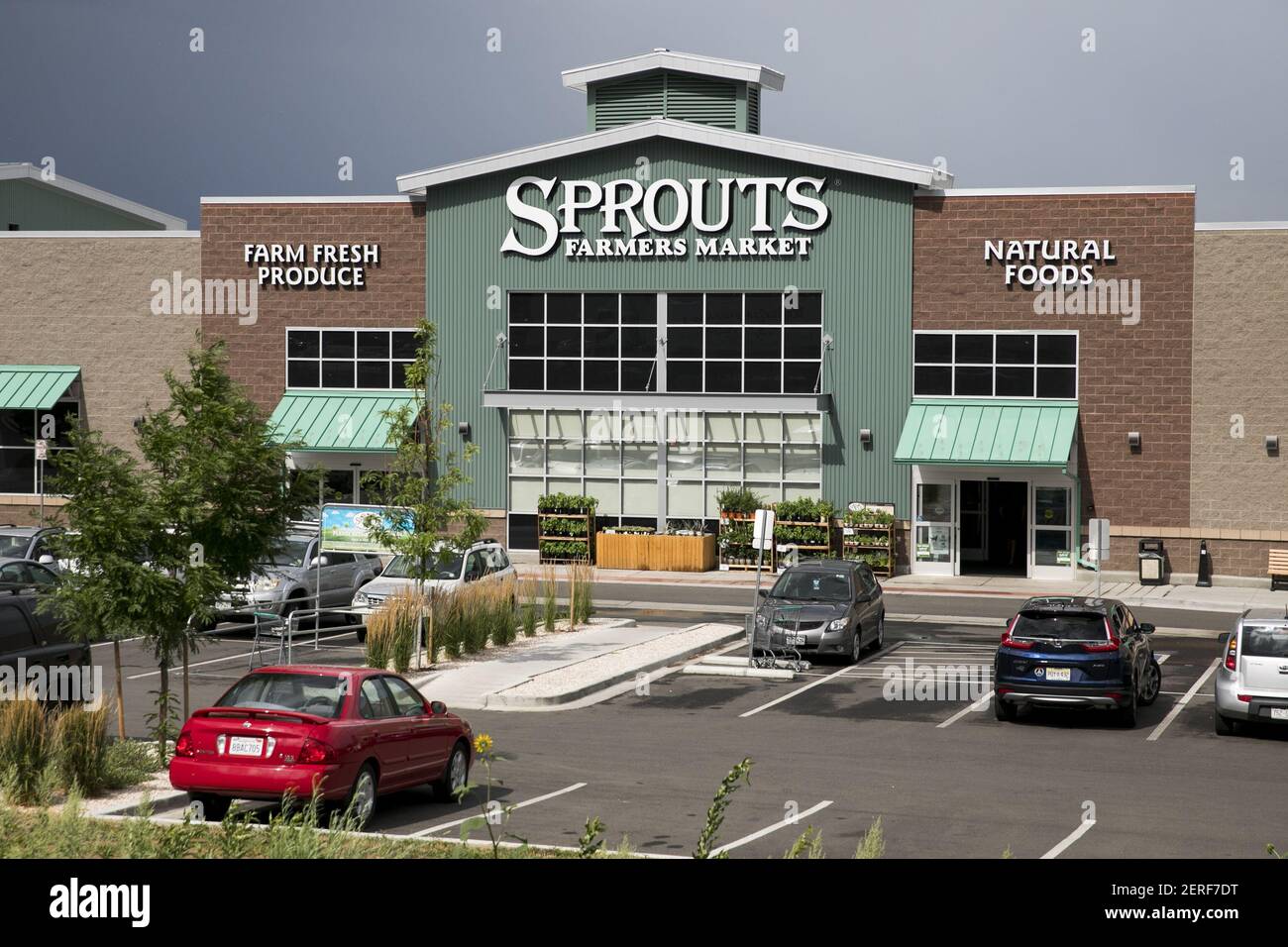 A logo sign outside of Sprouts Farmers Market retail grocery store in