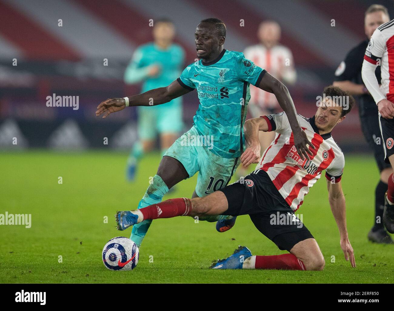 Sheffield. 1st Mar, 2021. Liverpool's Sadio Mane (L) is tackled by Sheffield United's Ethan Ampadu during the Premier League football match between Sheffield United FC and Liverpool FC in Sheffield, Britain, on Feb. 28, 2021. Credit: Xinhua/Alamy Live News Stock Photo