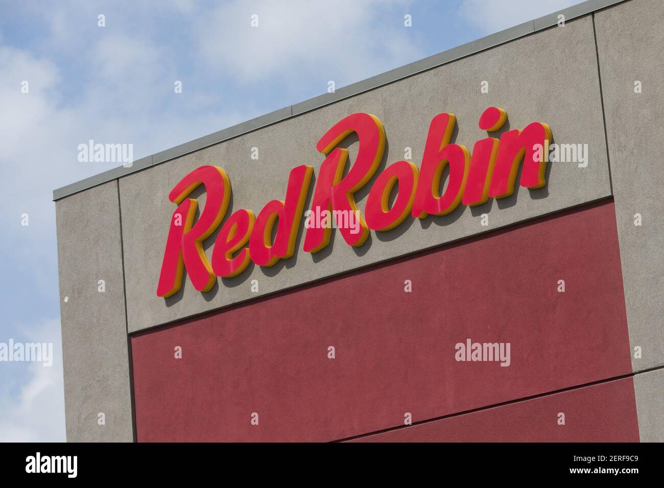 A logo sign outside of a Red Robin Gourmet Burgers and Brews restaurant
