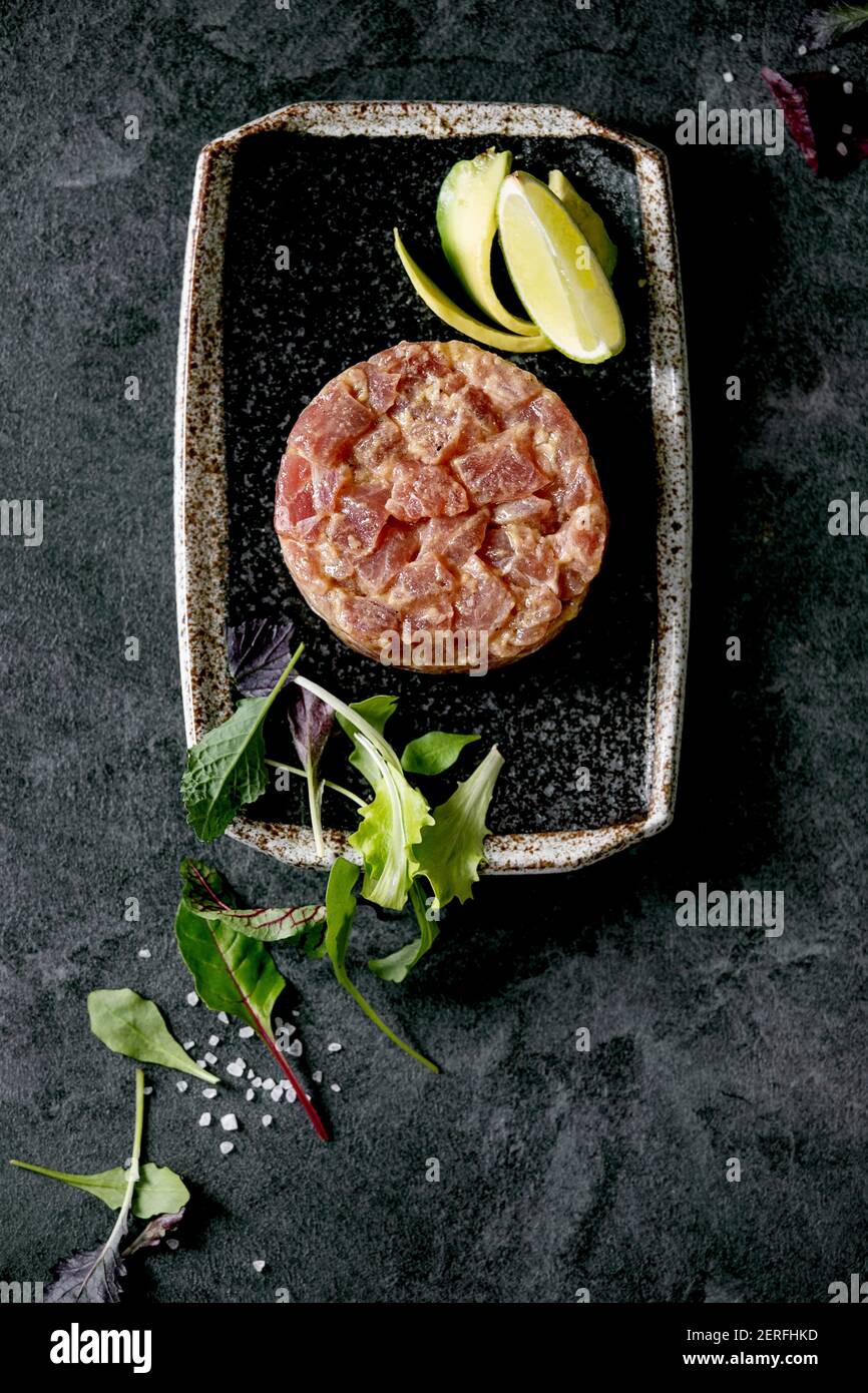 Tuna tartare with green salad, lime, avocado and mustard sauce serving
