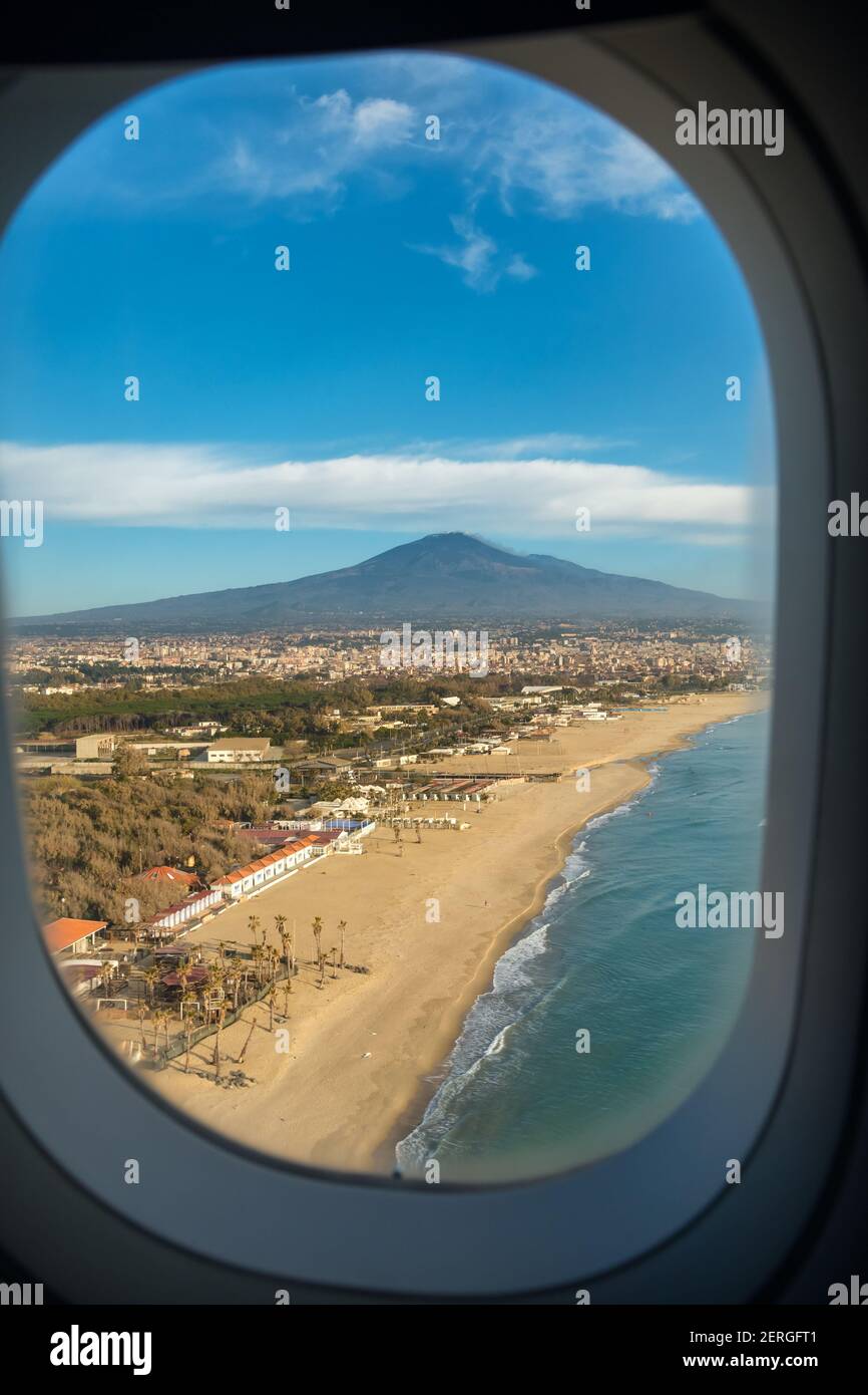 Mount Etna volcano and an empty beach seen from the plane in Sicily Stock Photo