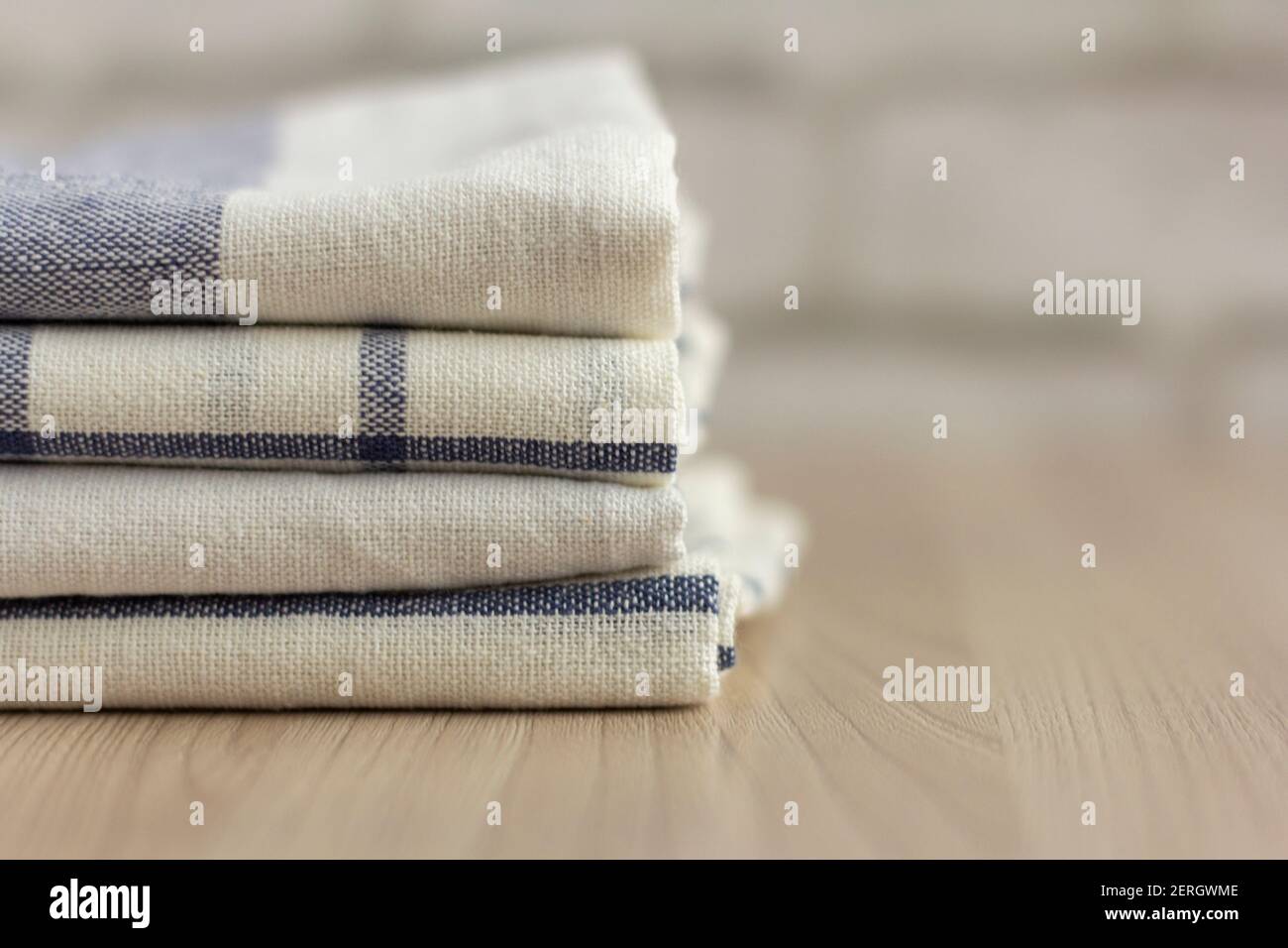 A stack of folded kitchen towels lies on the surface. Stock Photo