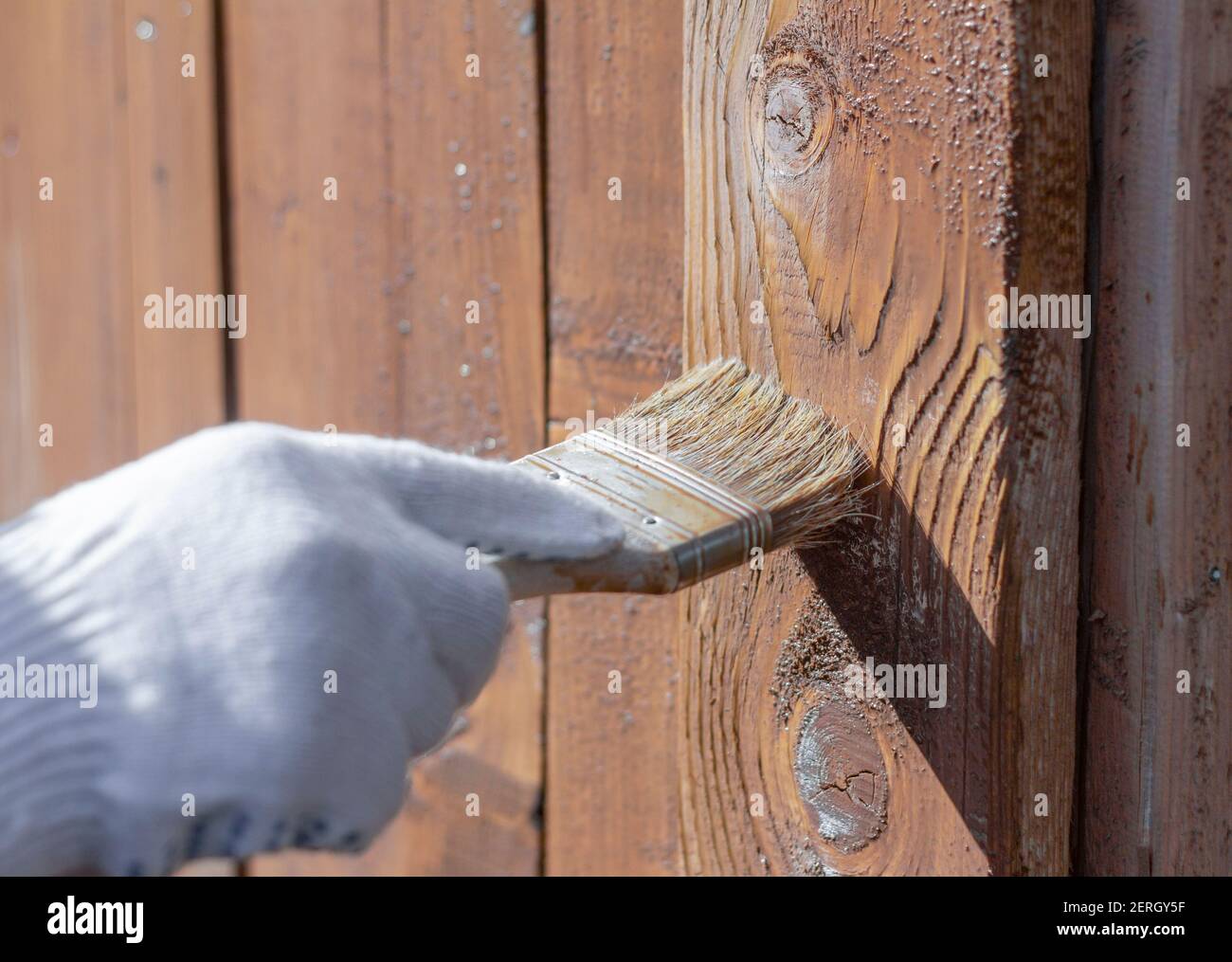 Closeup Of Hand Wearing Protective Work Gloves With Brush Paintbrush  Applying Stain To Cedar Wood Shingles Exterior Siding Home Maintenance  Renovation Improvement Diy Projects Stock Photo - Download Image Now -  iStock