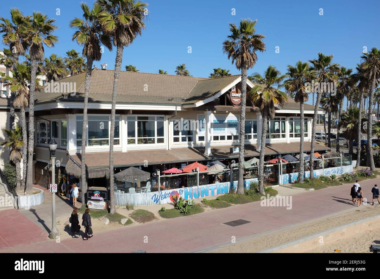 HUNTINGTON BEACH, CALIFORNIA - 25 FEB 2021: Dukes Restaurant and Sandys Beach Shack seen from the Pier Stock Photo