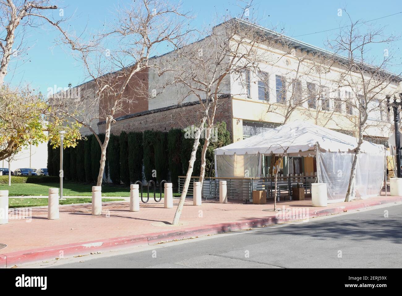 SANTA ANA, CALIFORNIA - 25 FEB 2021: Awnings and tents on a sidewalk outside a restaurant during the pandemic. Stock Photo