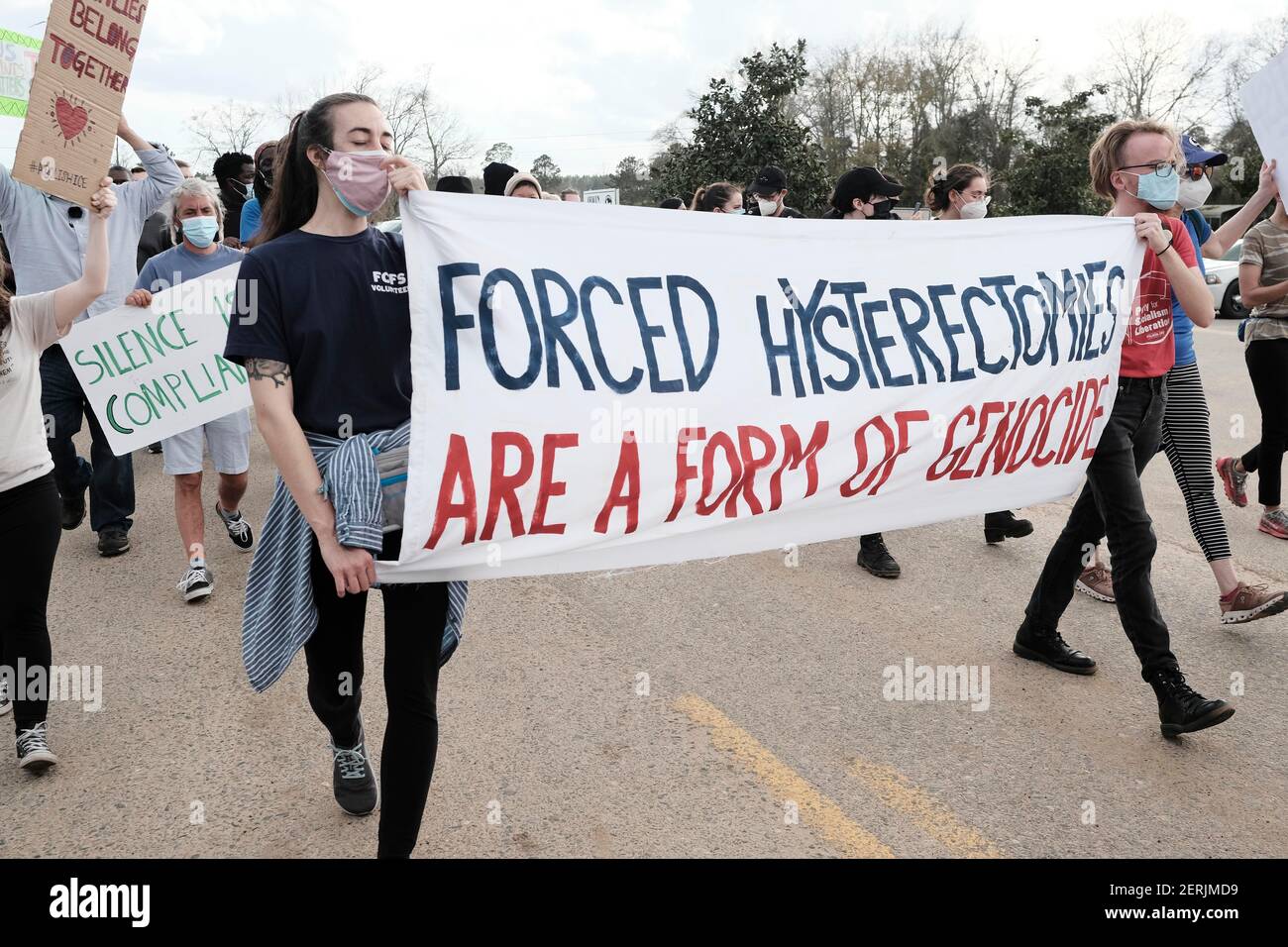 Ocilla, USA. 28th Feb, 2021. Two demonstrators carry a sign