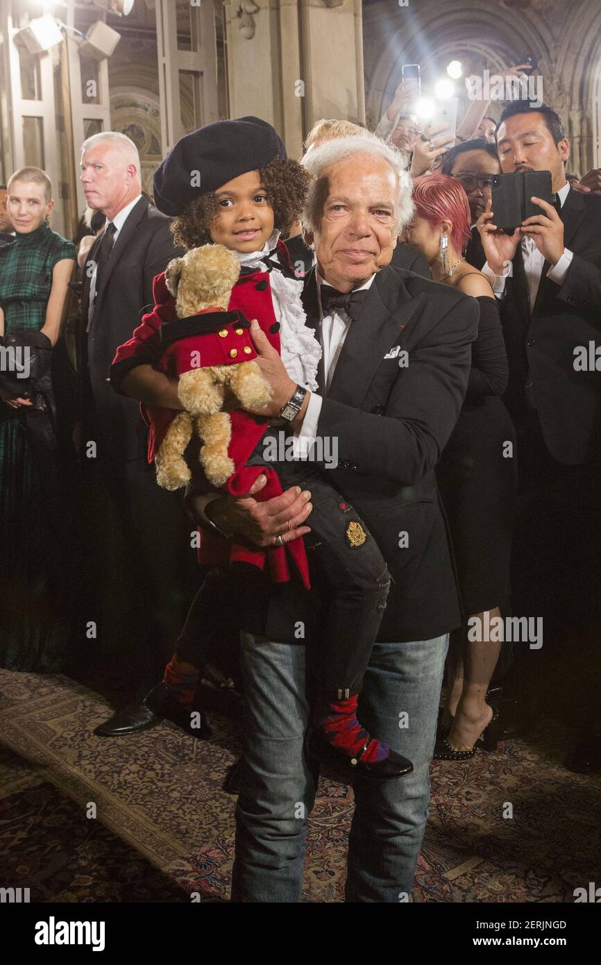 Ralph Lauren taking a bow with a young model at the conclusion of