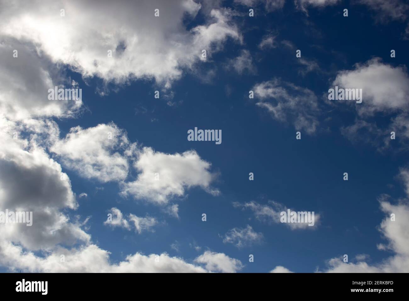 Cloudy day, white clouds in the blue sky, scattered clouds. Stock Photo