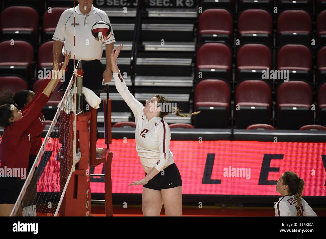 September 14, 2018 Washington State Cougars Claire Martin (12) tries to tip  the ball over the finger tips of Northern Illinois Huskies Grace  Balensiefer (7) and Northern Illinois Huskies Autumn Martin (14)