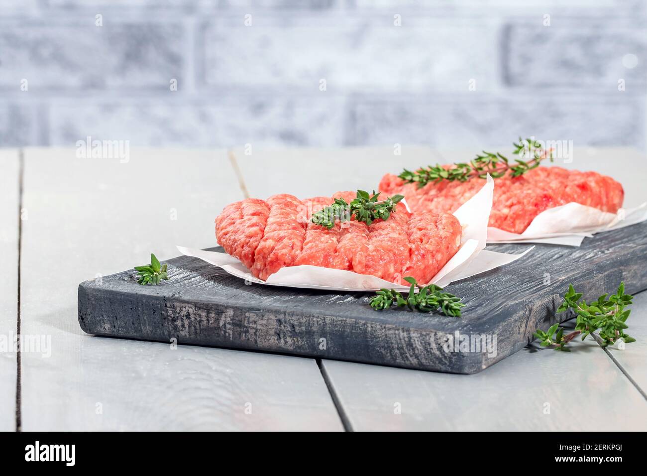 Raw minced beef patties for burgers. Raw meat for hamburgers. Beef cutlets. Stock Photo