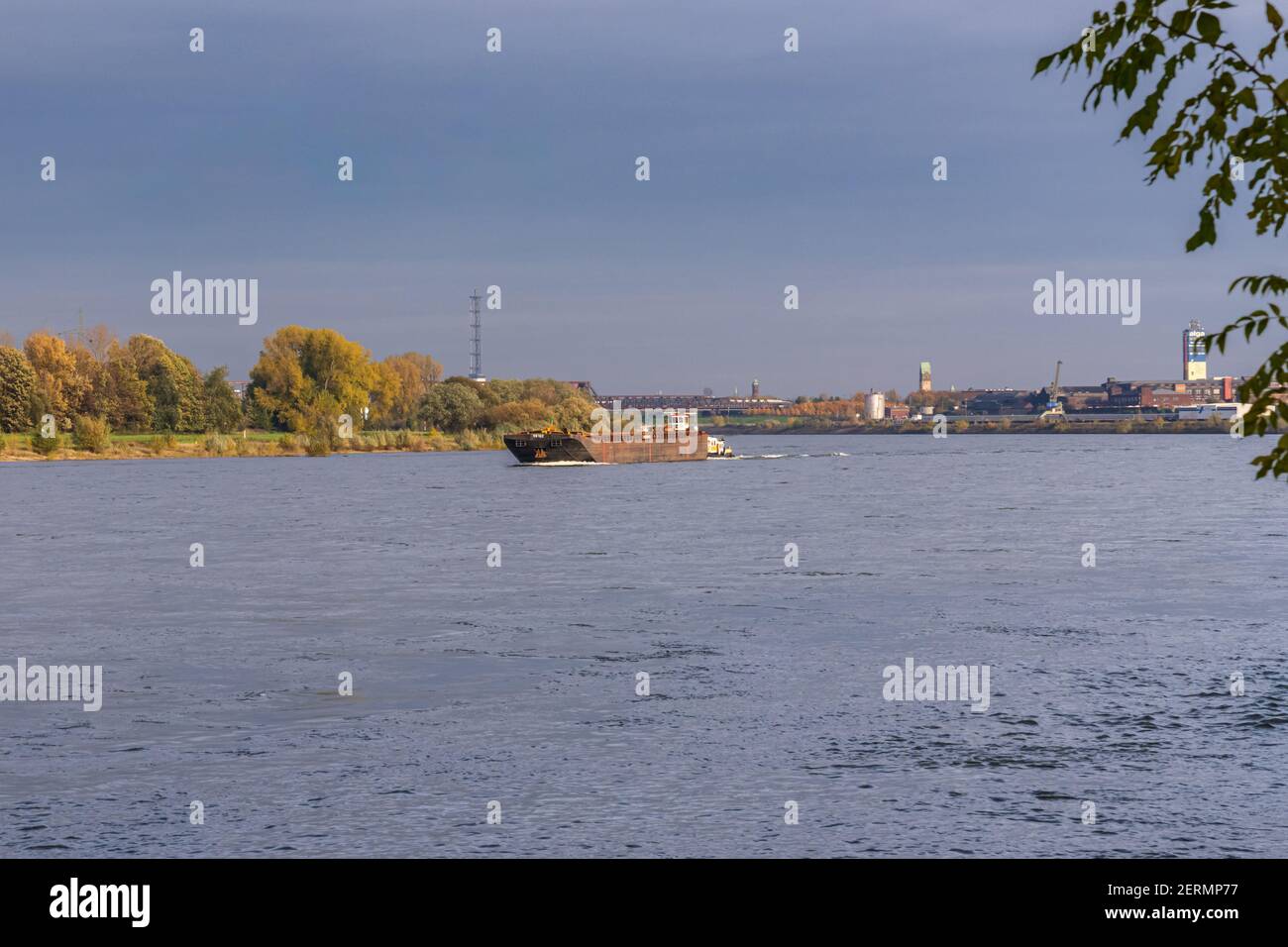 Duisburg, North Rhine-Westfalia, Germany - November 11, 2019: Ships on the River Rhine, seen from the Rheinpromenade Wanheim Stock Photo