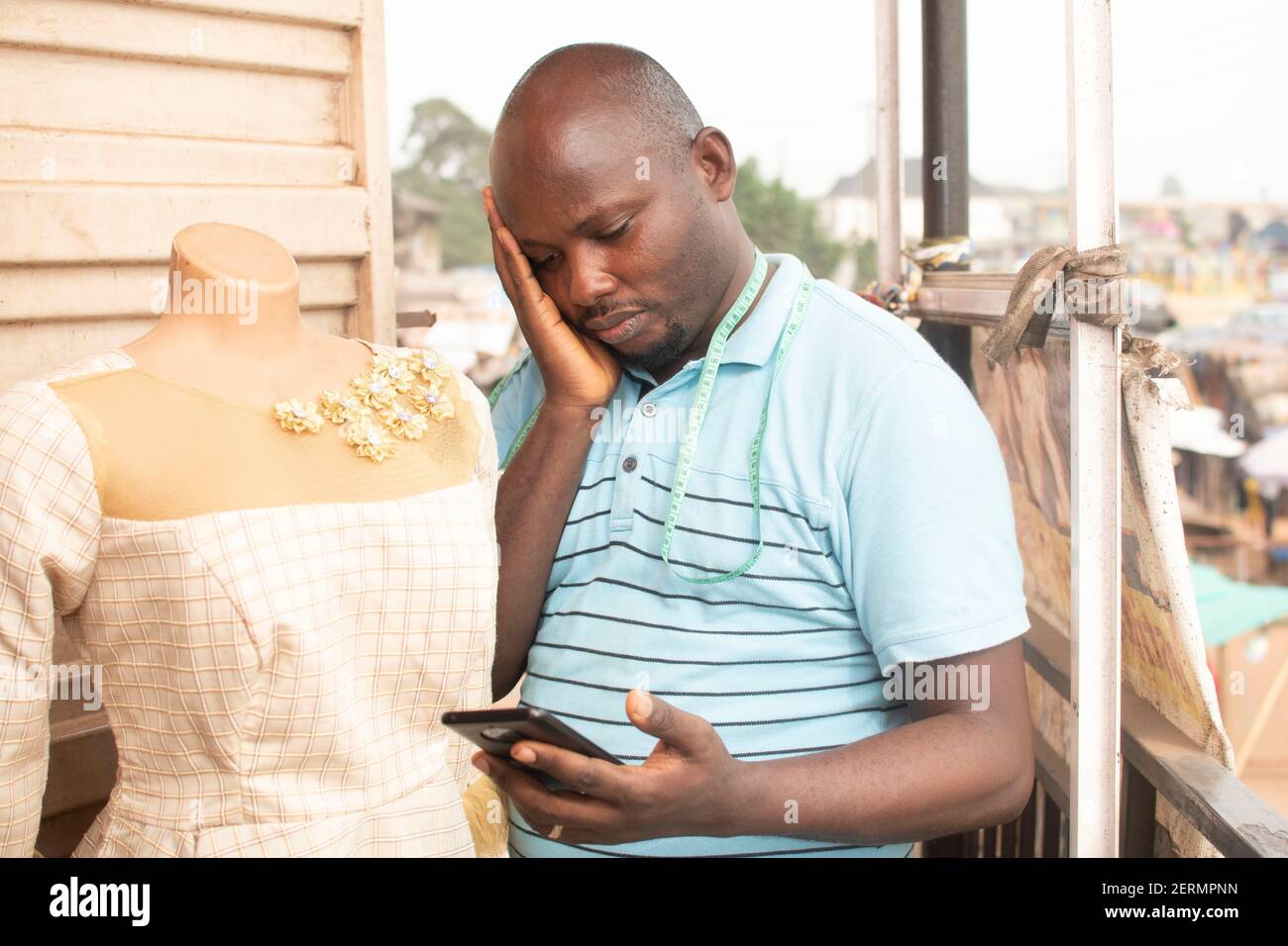 an african man looking into his phone Stock Photo