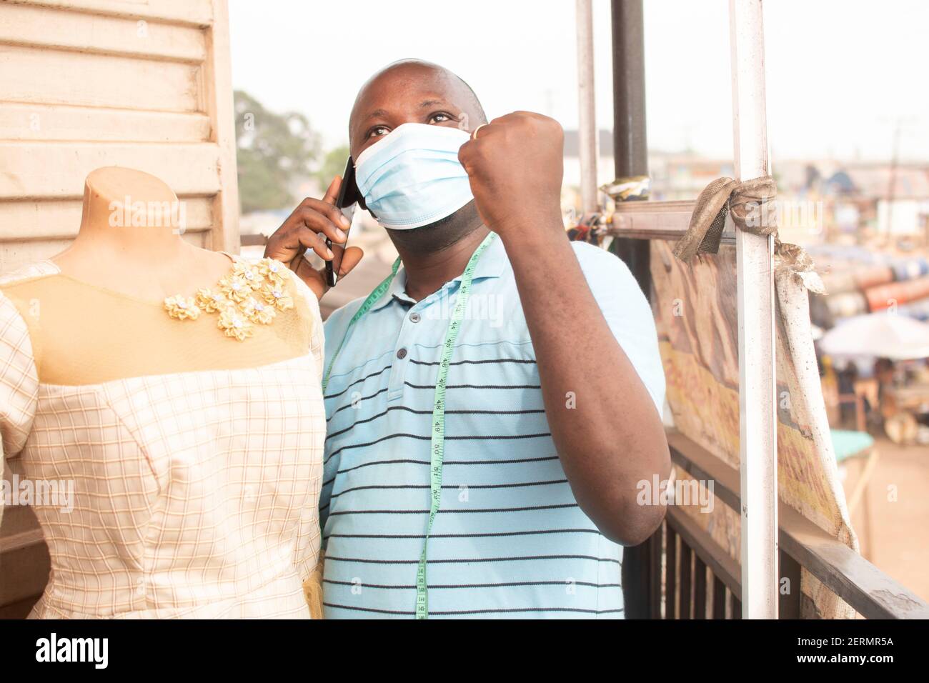 a man using his facemask while holding his fist Stock Photo