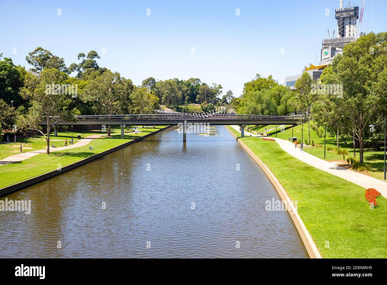 Parramatta river in the city centre with green open space on the foreshore and pedestrian bridge across the parramatta river,Western Sydney,Australia Stock Photo